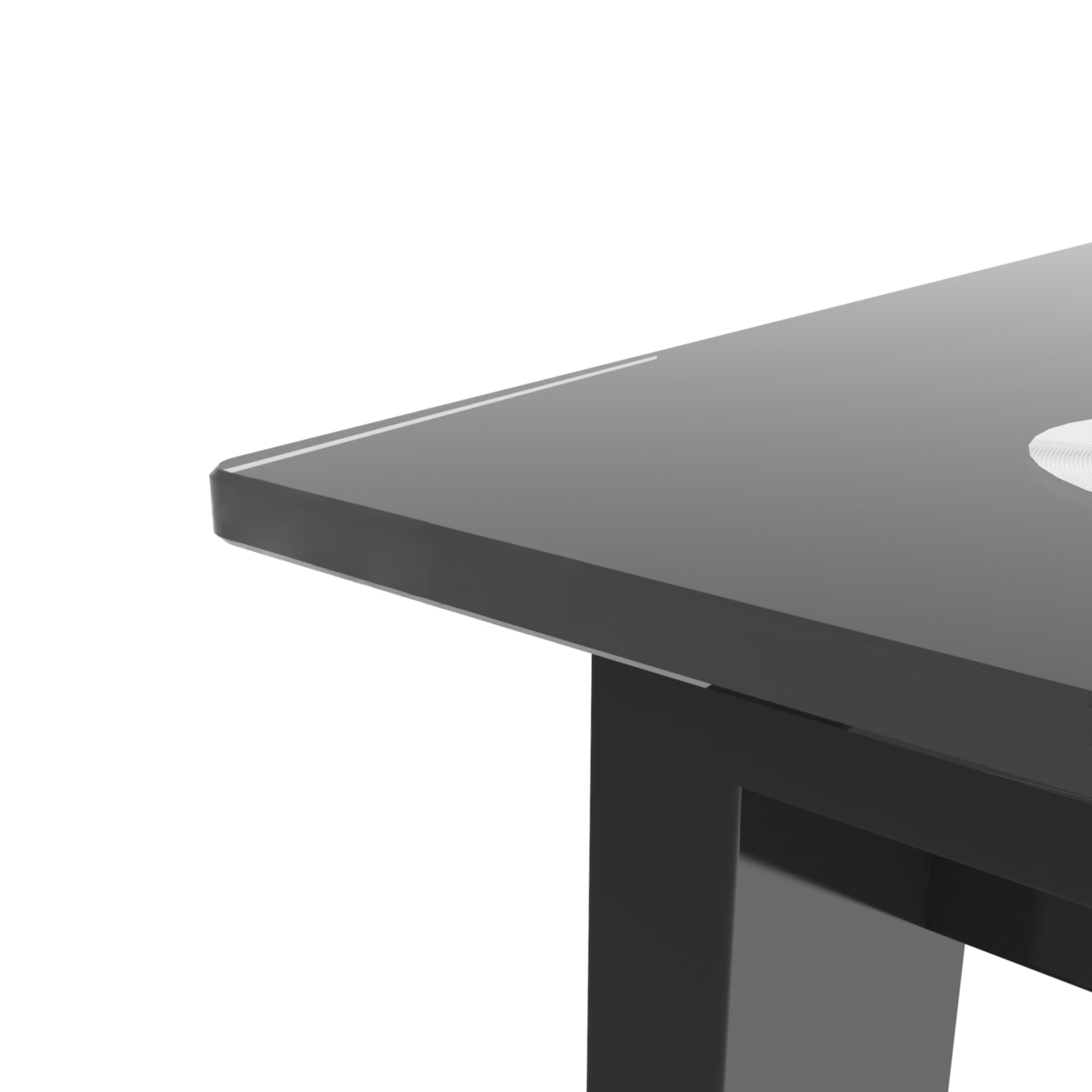 Close-up of the black glass tabletop corner and edge with an aluminum disk fitting