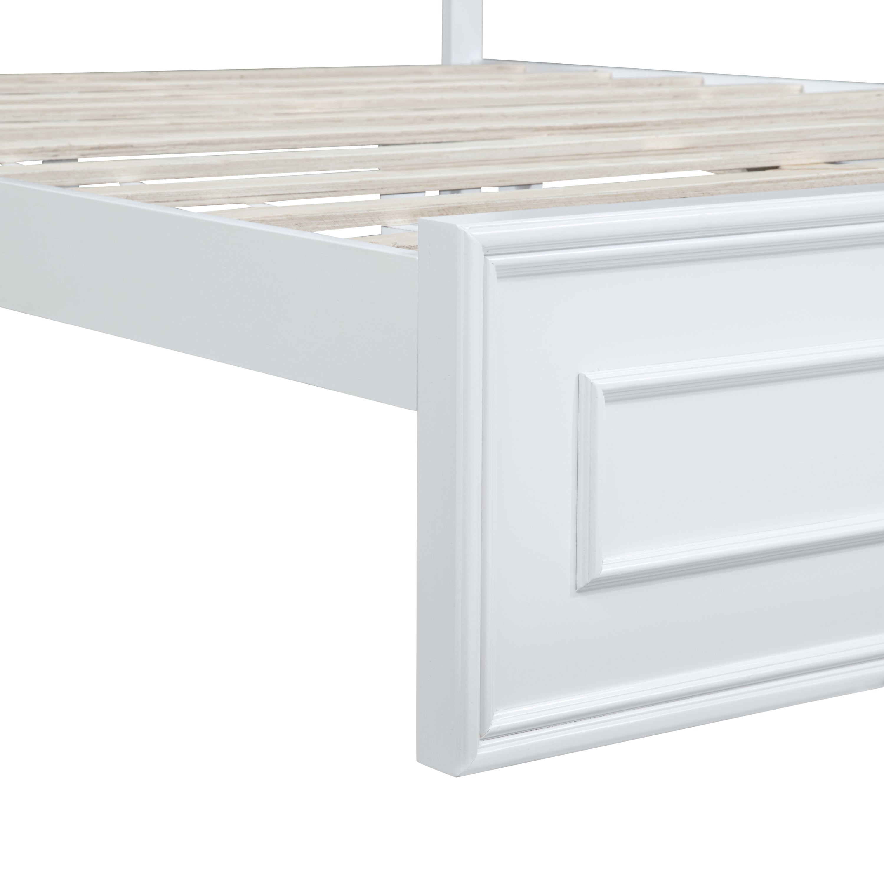 Close-up of the raised-panel footboard corner and wood slats on a white queen bed #Color_White