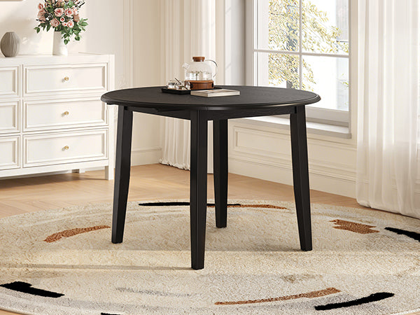 Styled room with the black table, one drop leaf folded down by a dresser