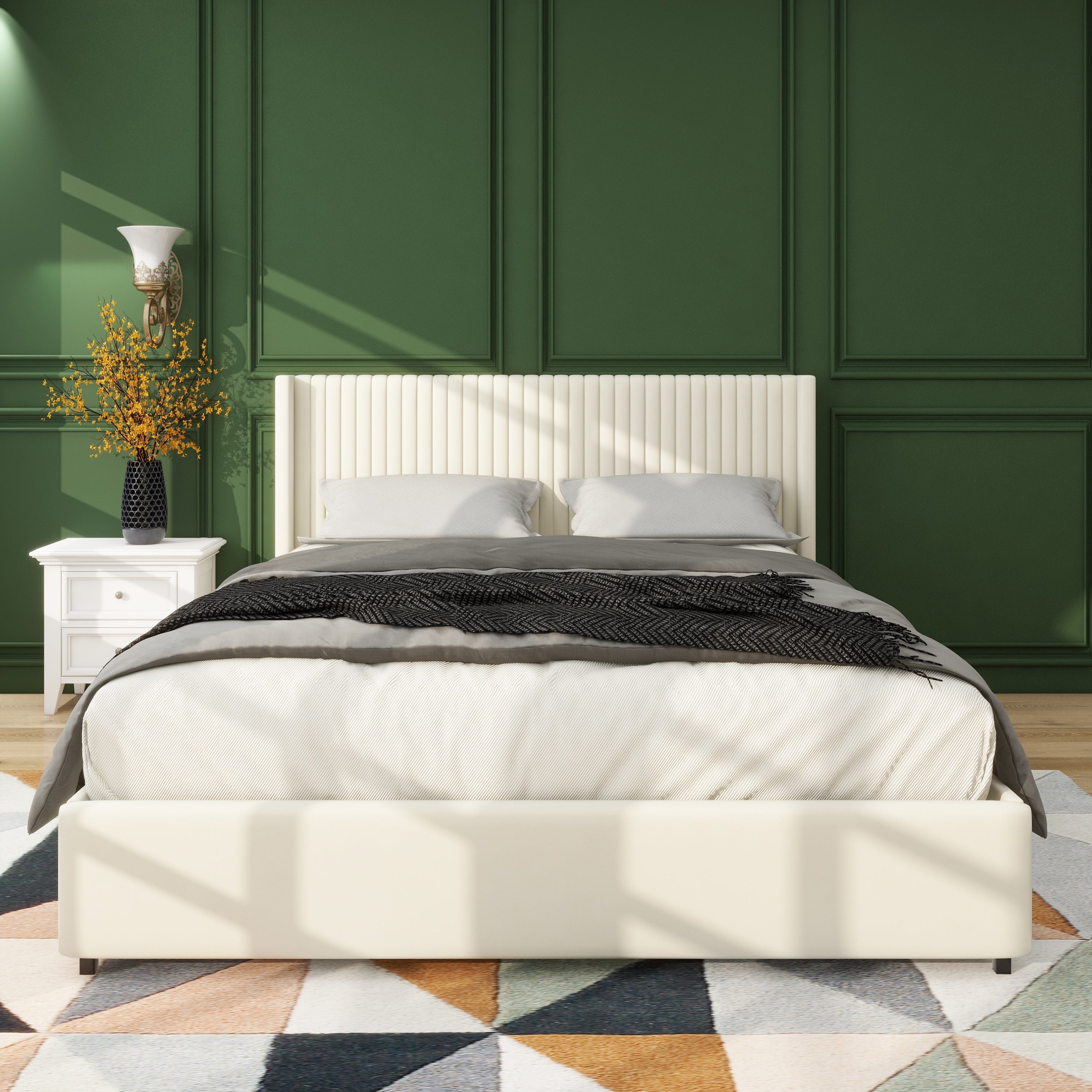 Front view of the ivory velvet wingback storage bed with vertical channels against a green paneled wall