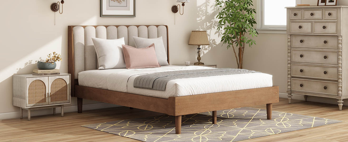 Angled bedroom view of the wheat piano-key bed frame and headboard beside a rattan nightstand and dresser