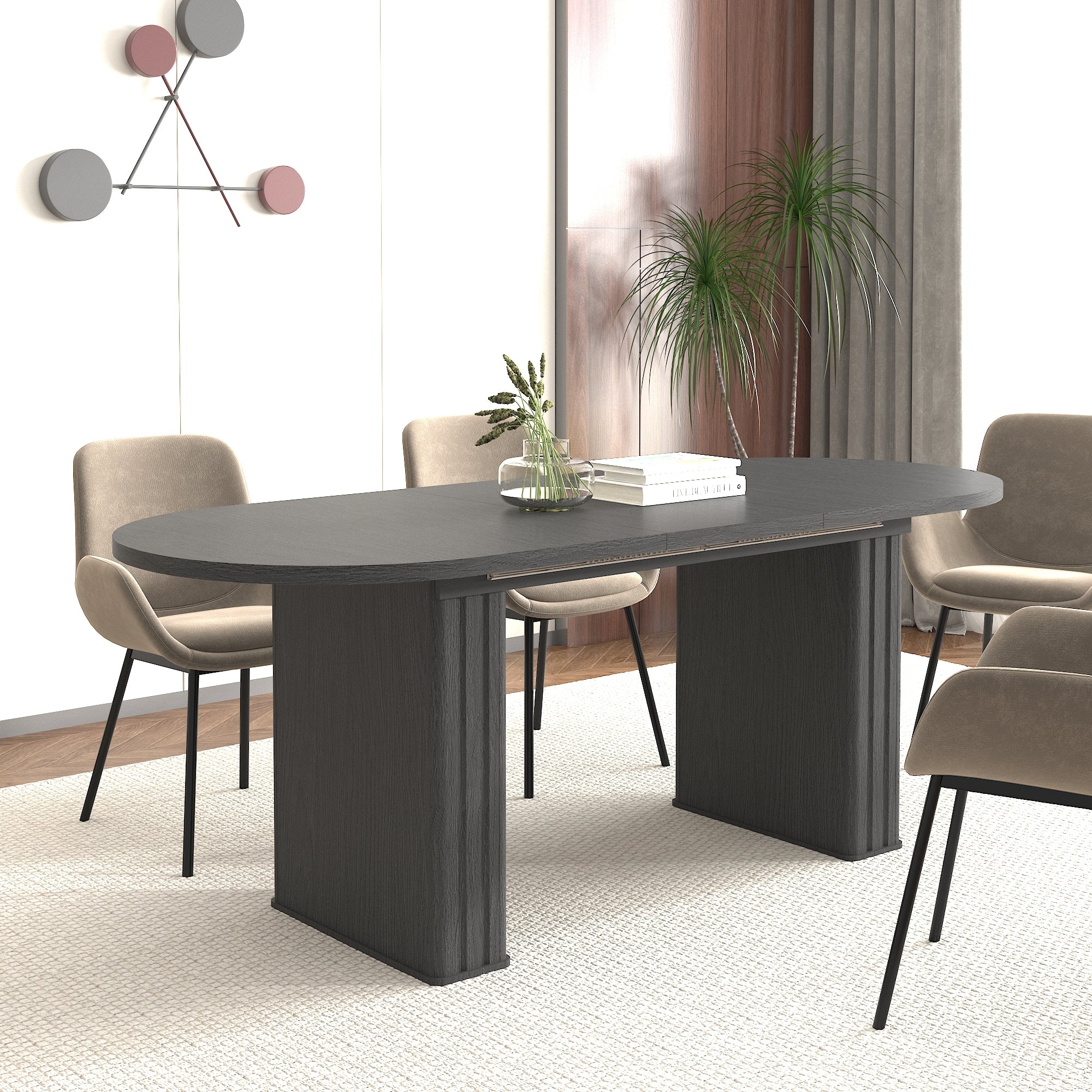 Black oval extendable dining table with four tan chairs in a sunlit dining room, angled view