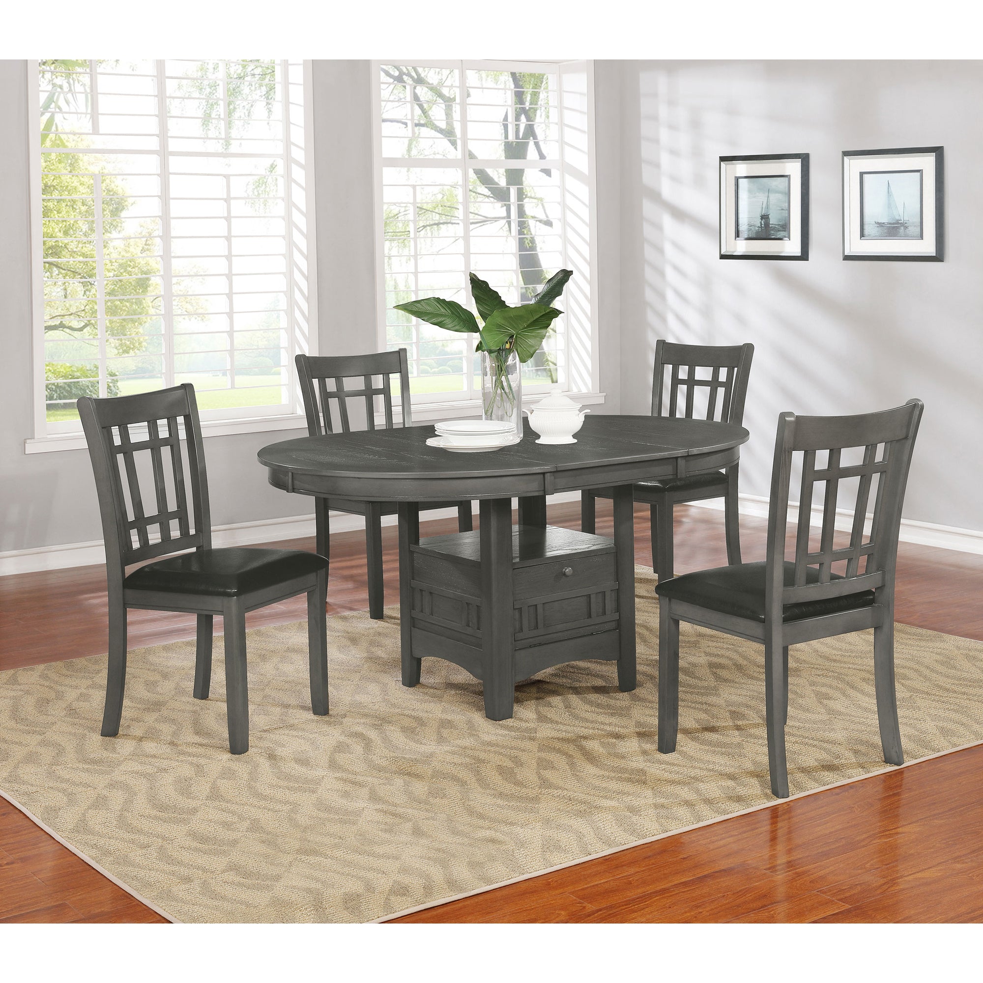 Grey oval dining set styled with tableware and the fold-down base shelf open