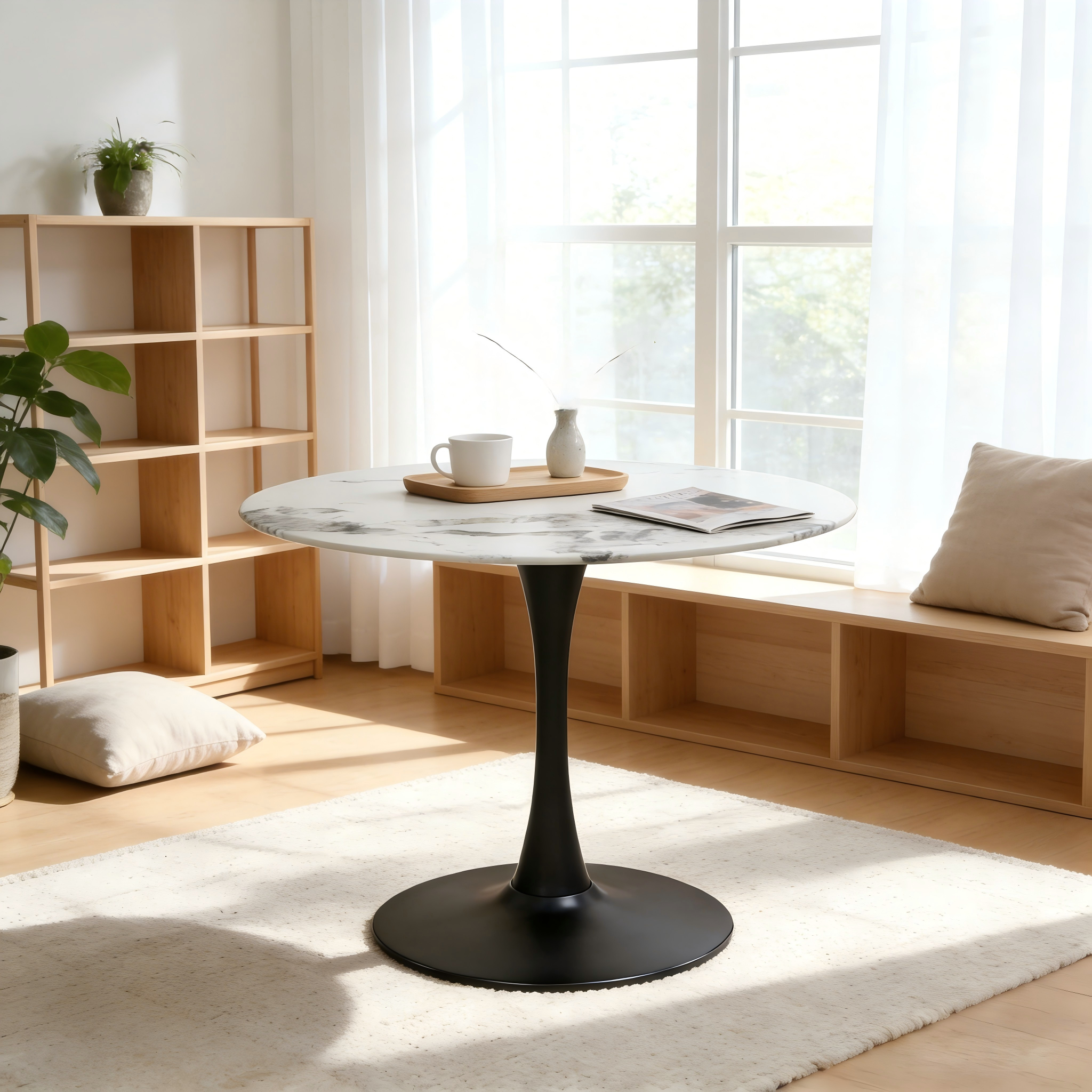 Faux marble tulip dining table with black pedestal by a window beside wood shelving