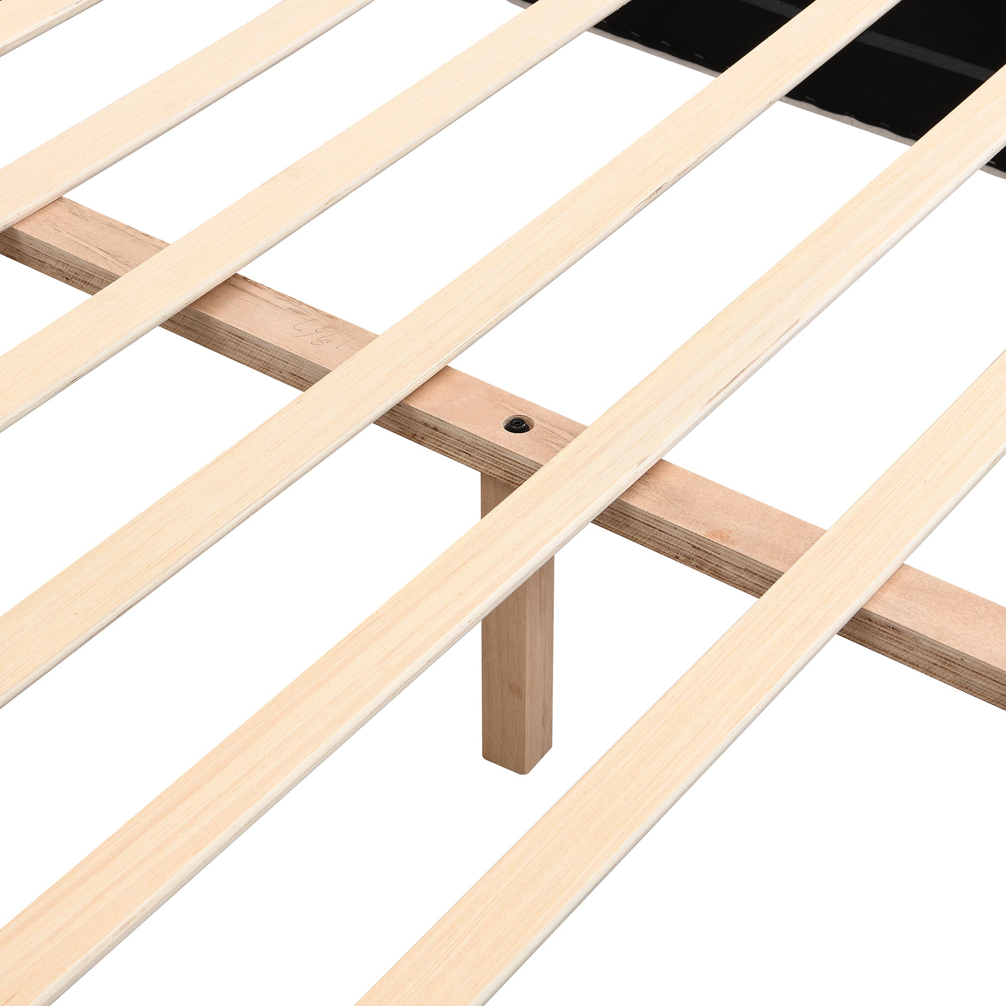 Close-up of wood slat and support leg joint under bed frame