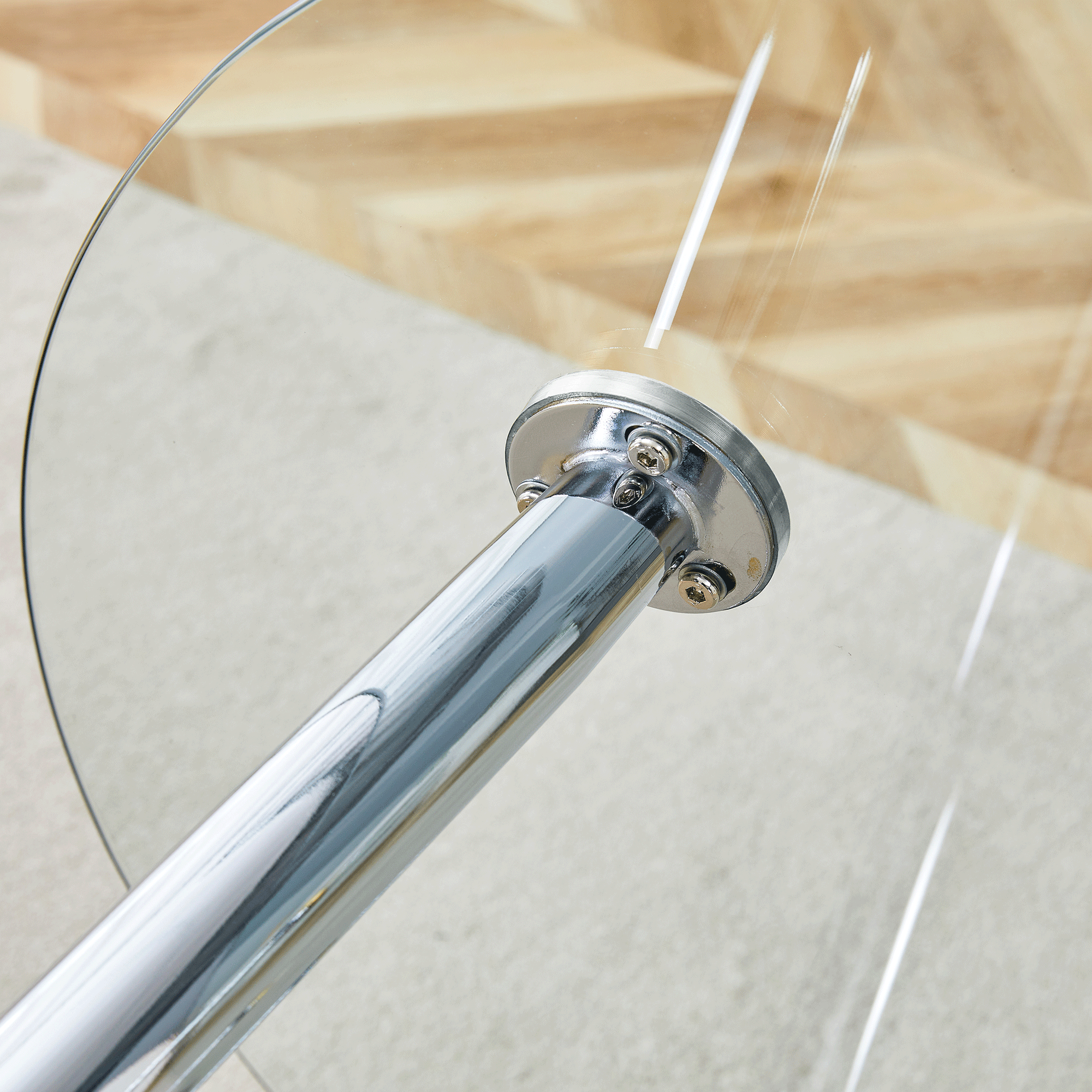 Overhead close-up of a silver suction-cup leg mount fastened under the glass tabletop