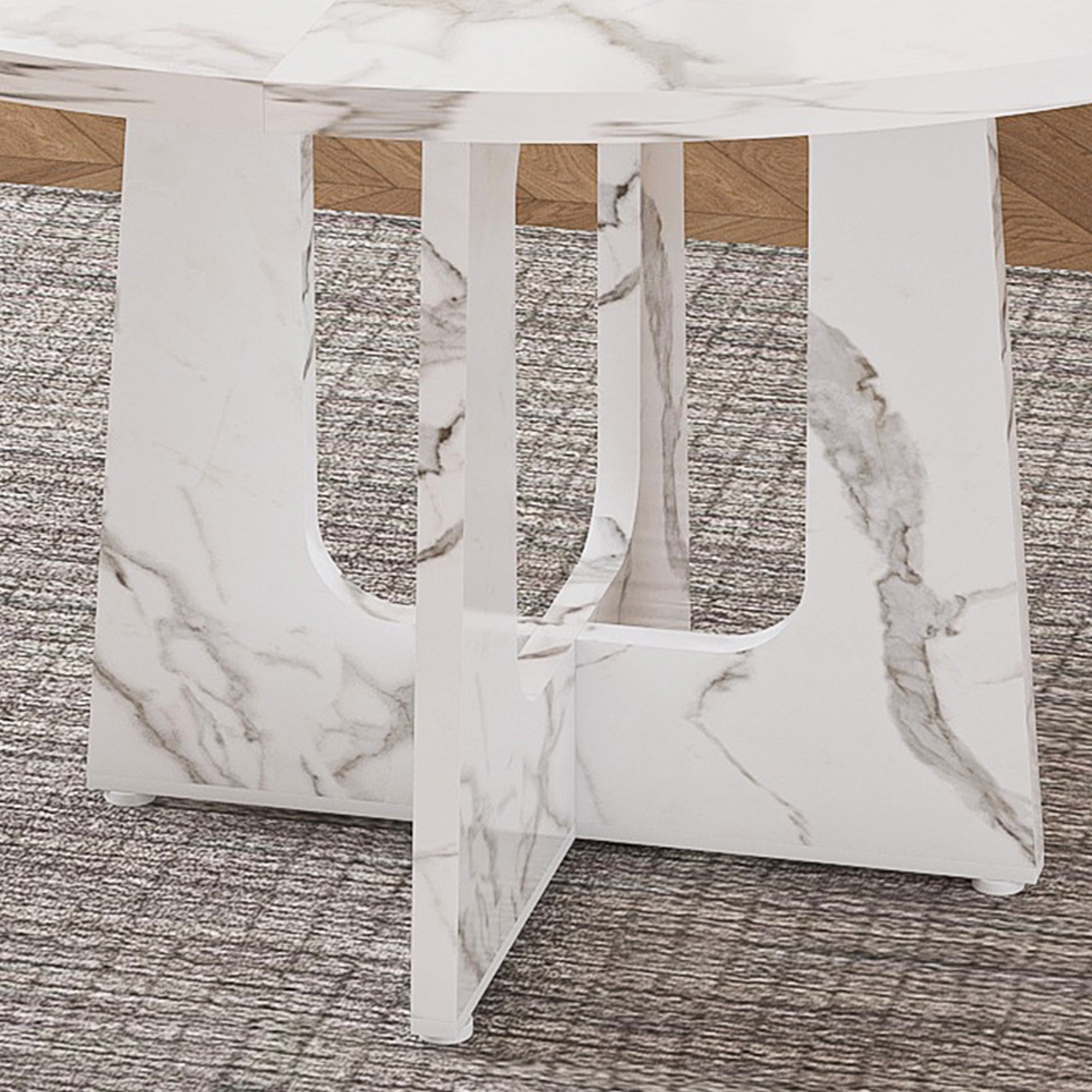 Close-up of the arched-cutout faux marble cross pedestal base on a gray rug