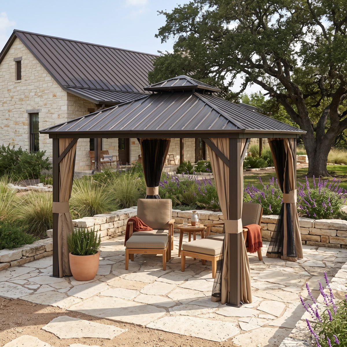 Brown aluminum 10x10 double roof hardtop gazebo with tan curtains over lounge chairs on a stone patio in daylight