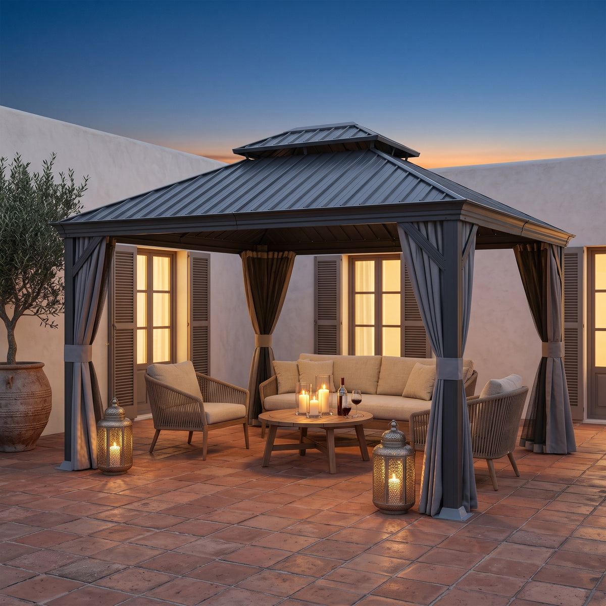 Gray steel 10x13 double roof hardtop gazebo with tied curtains over a lounge set on a terracotta patio at dusk