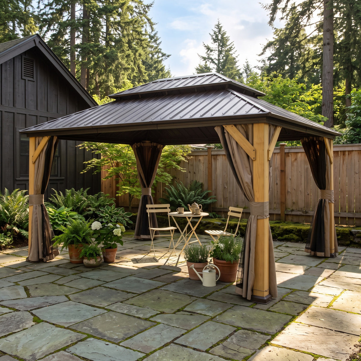 Brown cedar double roof hardtop gazebo with tan curtains over a bistro table on a flagstone patio by a wood fence