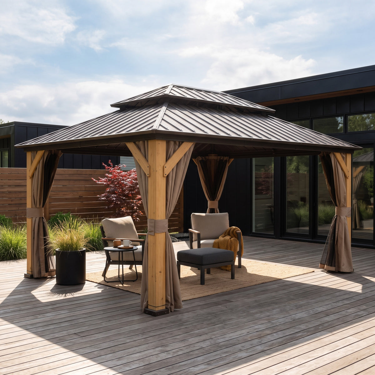 Brown steel double roof cedar gazebo with tan curtains tied back over lounge chairs on a sunny wood deck