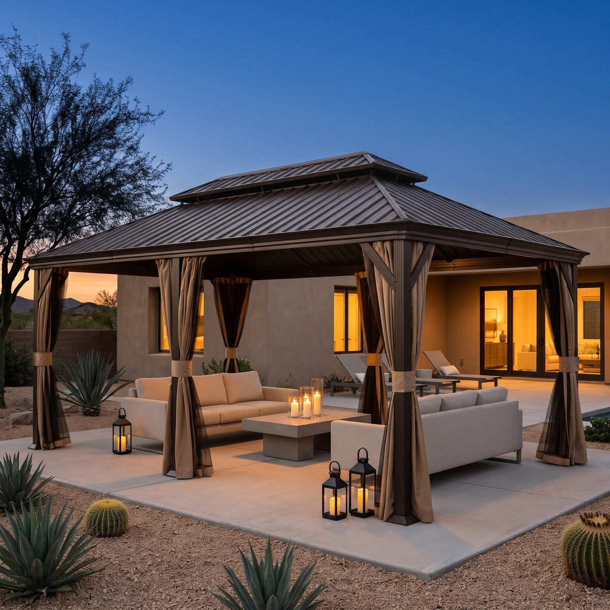 Brown steel 12x24 hardtop gazebo with tied back curtains over a sectional on a desert patio at dusk