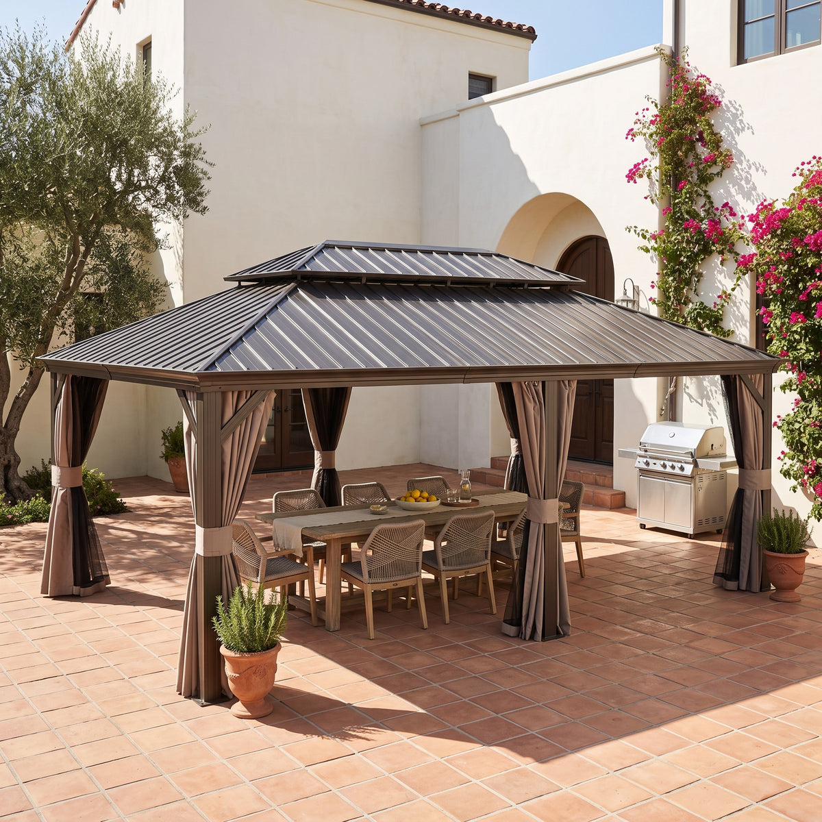 Brown aluminum 14x24 double roof hardtop gazebo with tied back curtains over a dining table on a terracotta patio