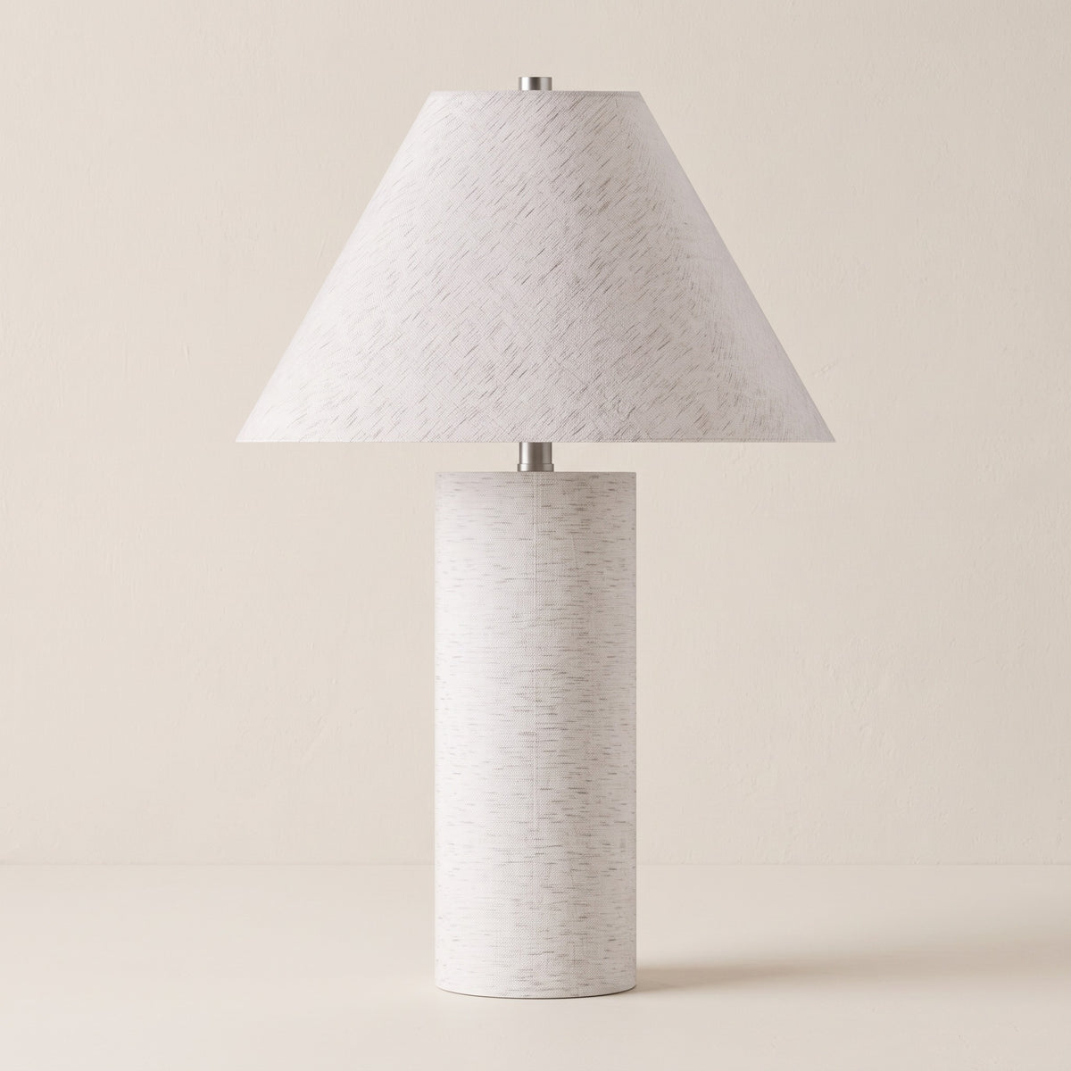 White table lamp with linen-look cylinder body and white linen coolie shade on an ivory backdrop