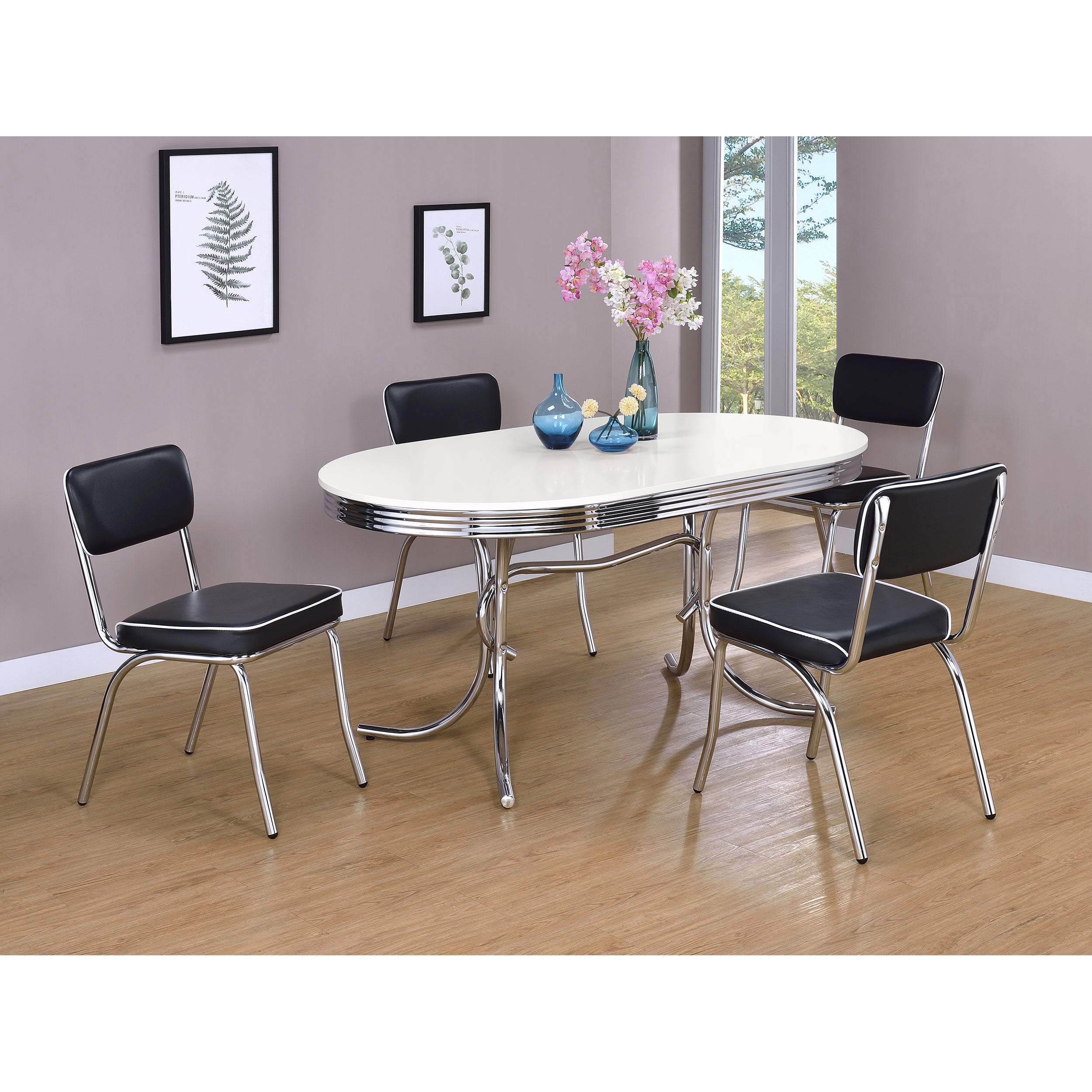 Styled dining set with the retro oval table and four black upholstered chrome chairs
