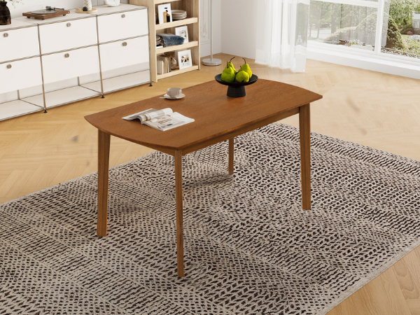 Overhead angled view of the brown dining table on a patterned rug in a sunlit room