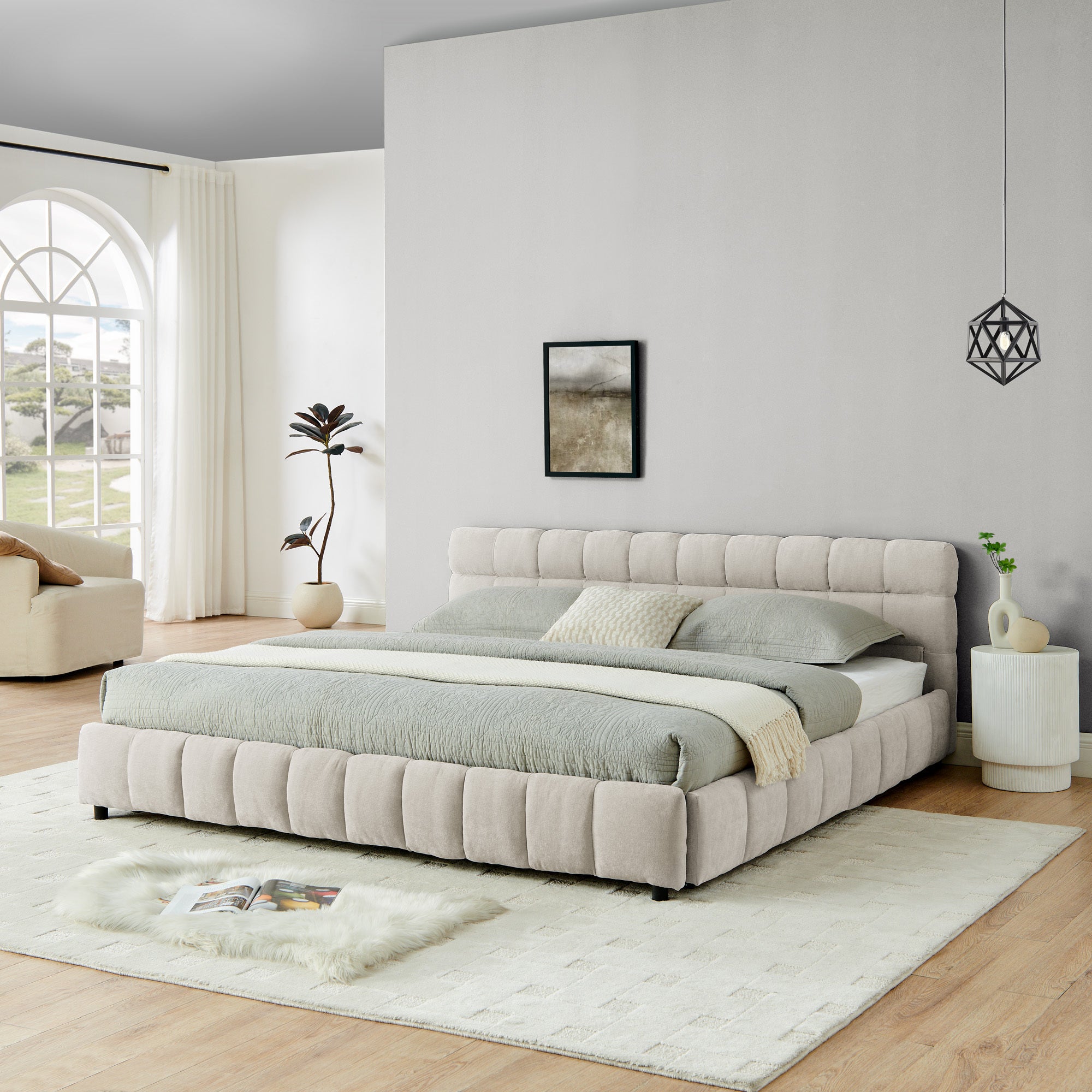 Front angle of beige chenille king bed with plant and side table
