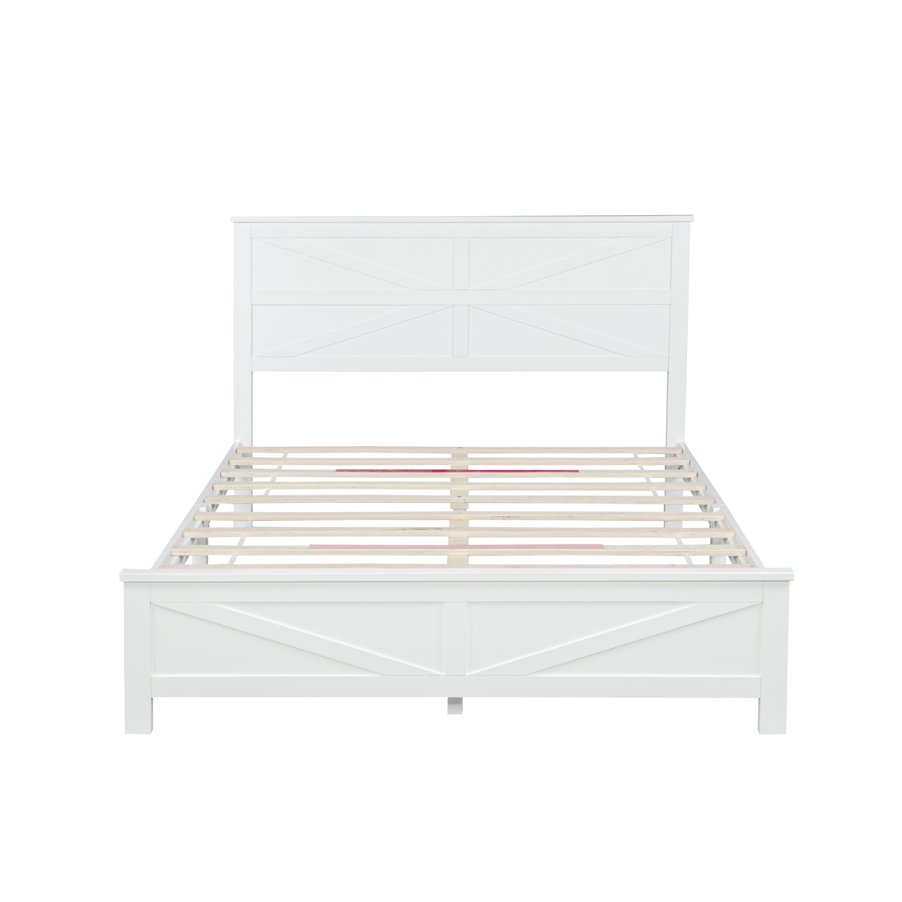 Front studio view of the bare white barn door bed frame with wood slats spanning the base