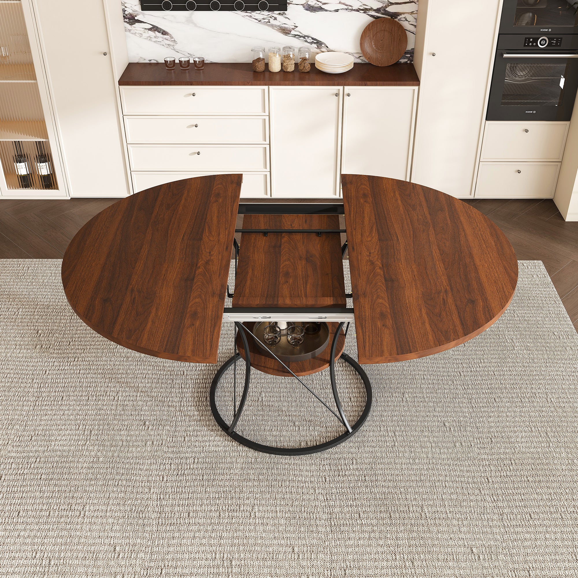 Overhead view of the walnut extendable round table split open mid-extension with the black iron base and shelf