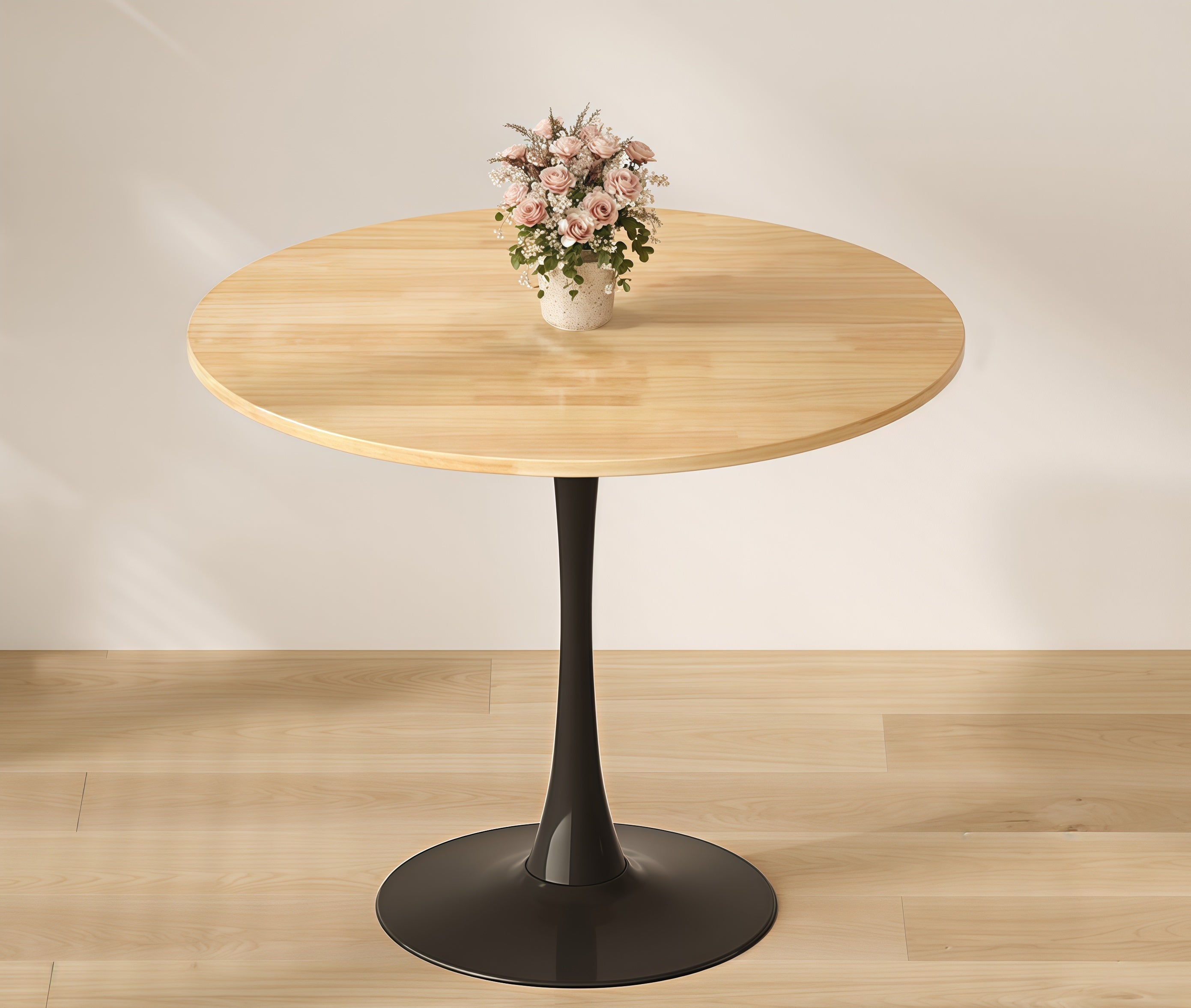 Natural wood round bistro table with pink flowers on a round rug in a sunlit room