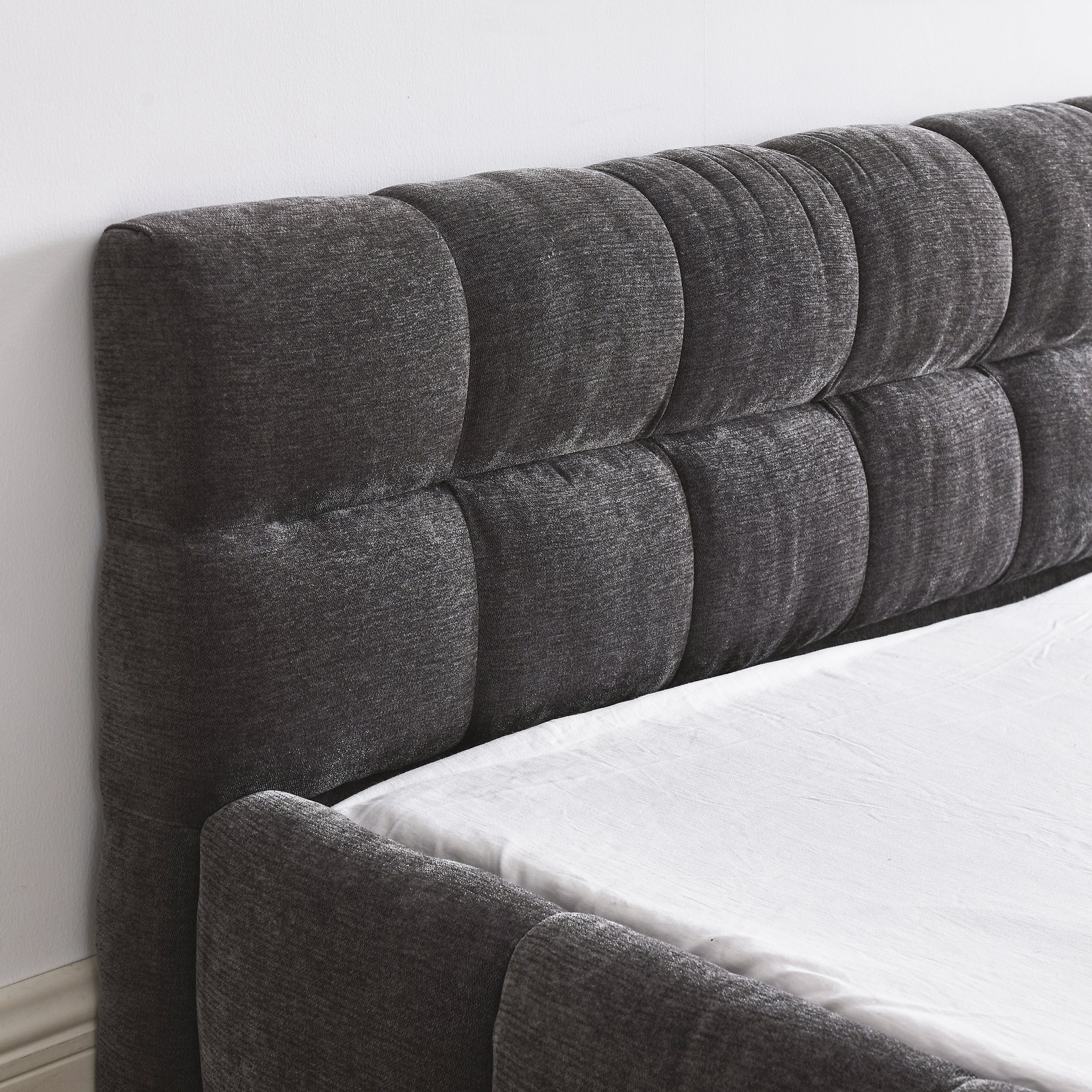 Close-up of the dark grey chenille channel-tufted headboard corner #Color_Dark Grey