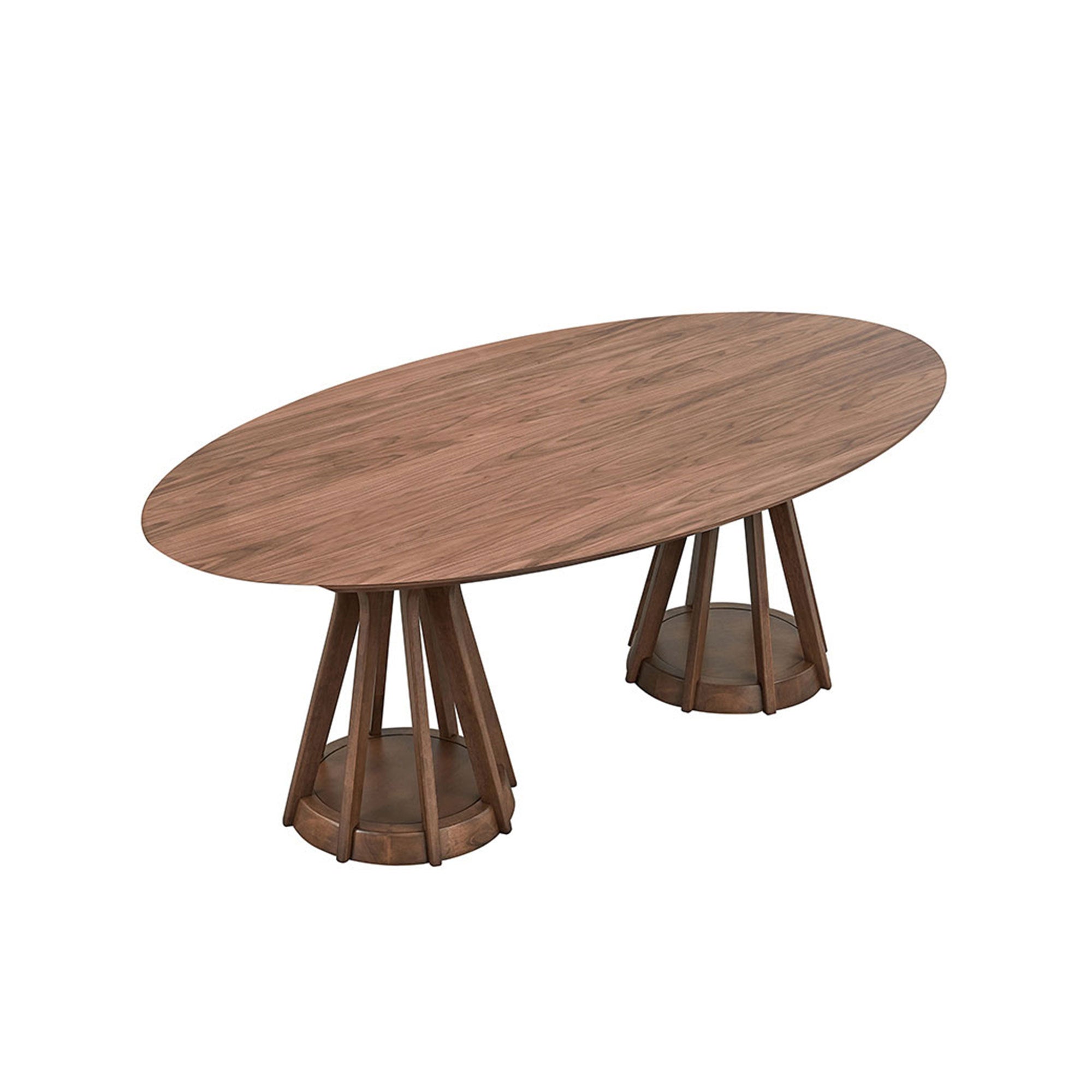 Angled overhead view of the walnut oval pedestal dining table on white