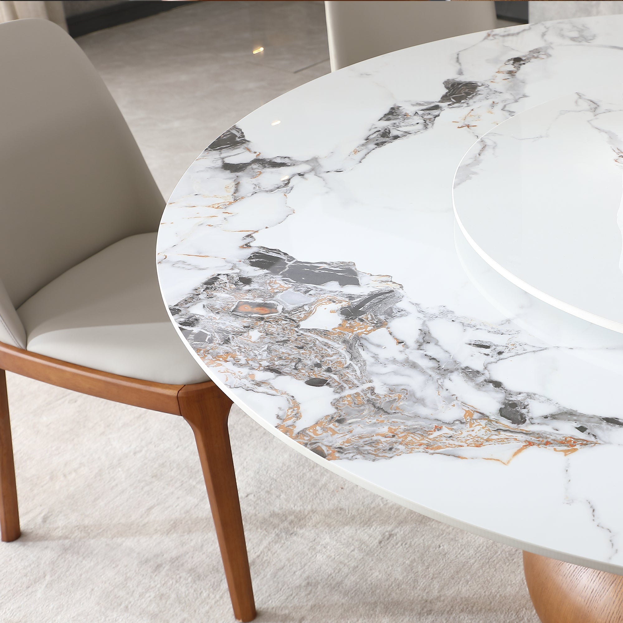 Close-up of the white marble-look tabletop edge with gray and gold veining beside the turntable