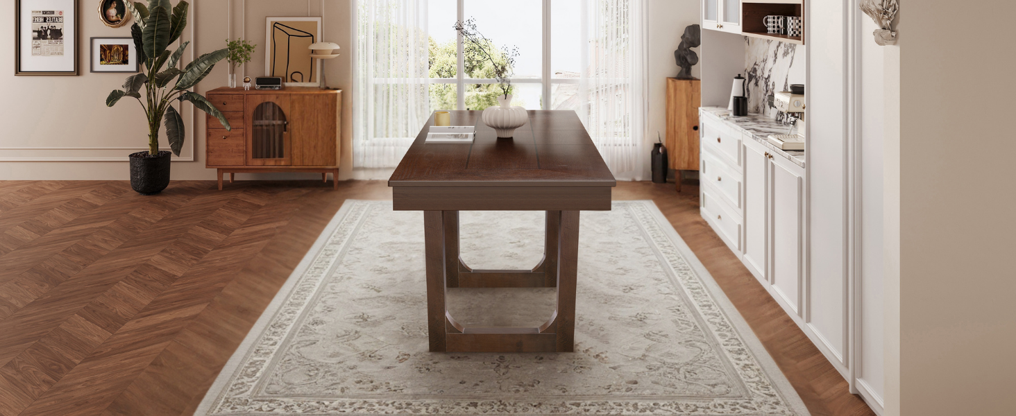 Wide angled end view of the walnut dining table on a large area rug