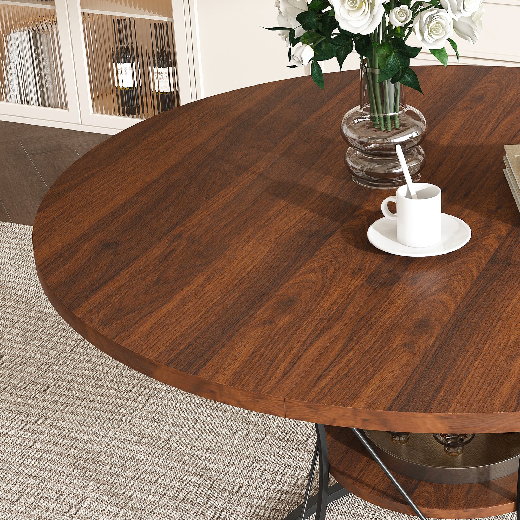 Walnut extendable round dining table with black iron cage base on a plain white background, three-quarter view