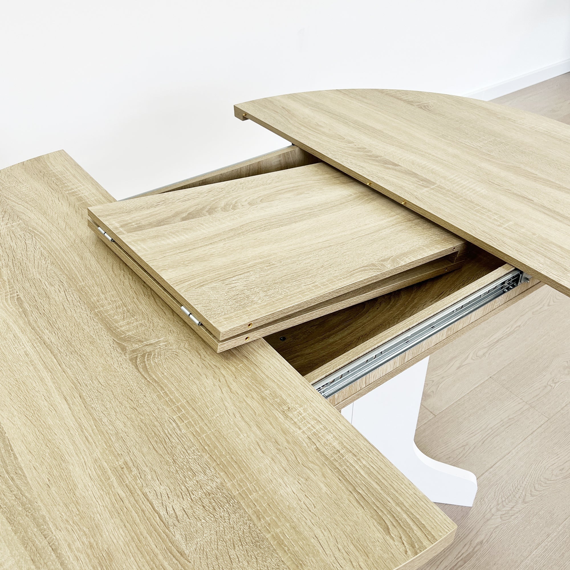 Close-up of the folding leaf half raised on its hinge with the slide rail exposed