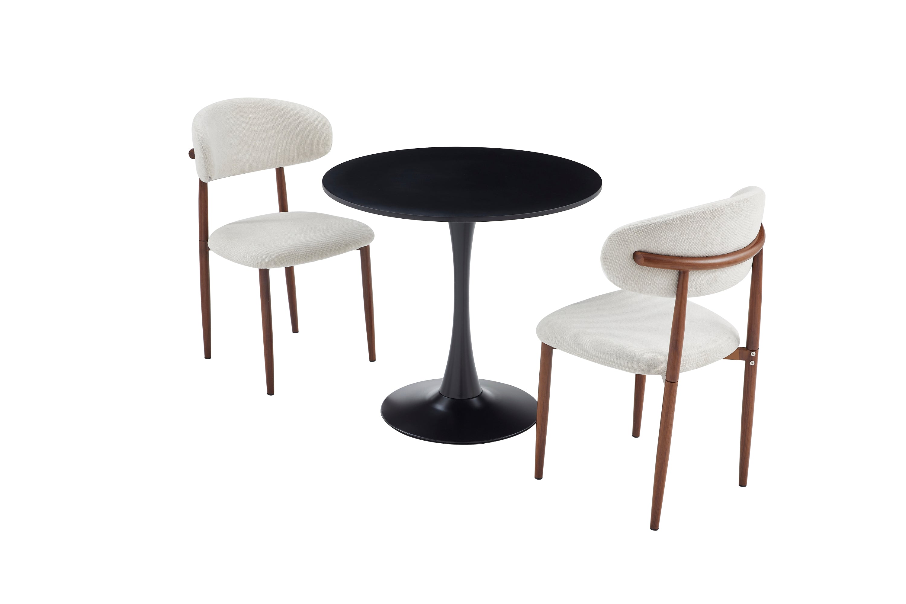 Black round dining table flanked by two cream and walnut dining chairs, white studio