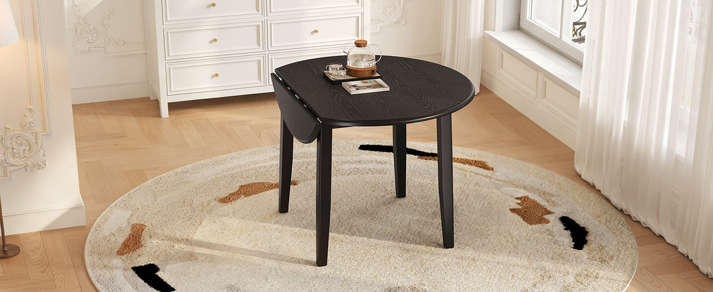 Overhead studio view of the black round wood-grain tabletop