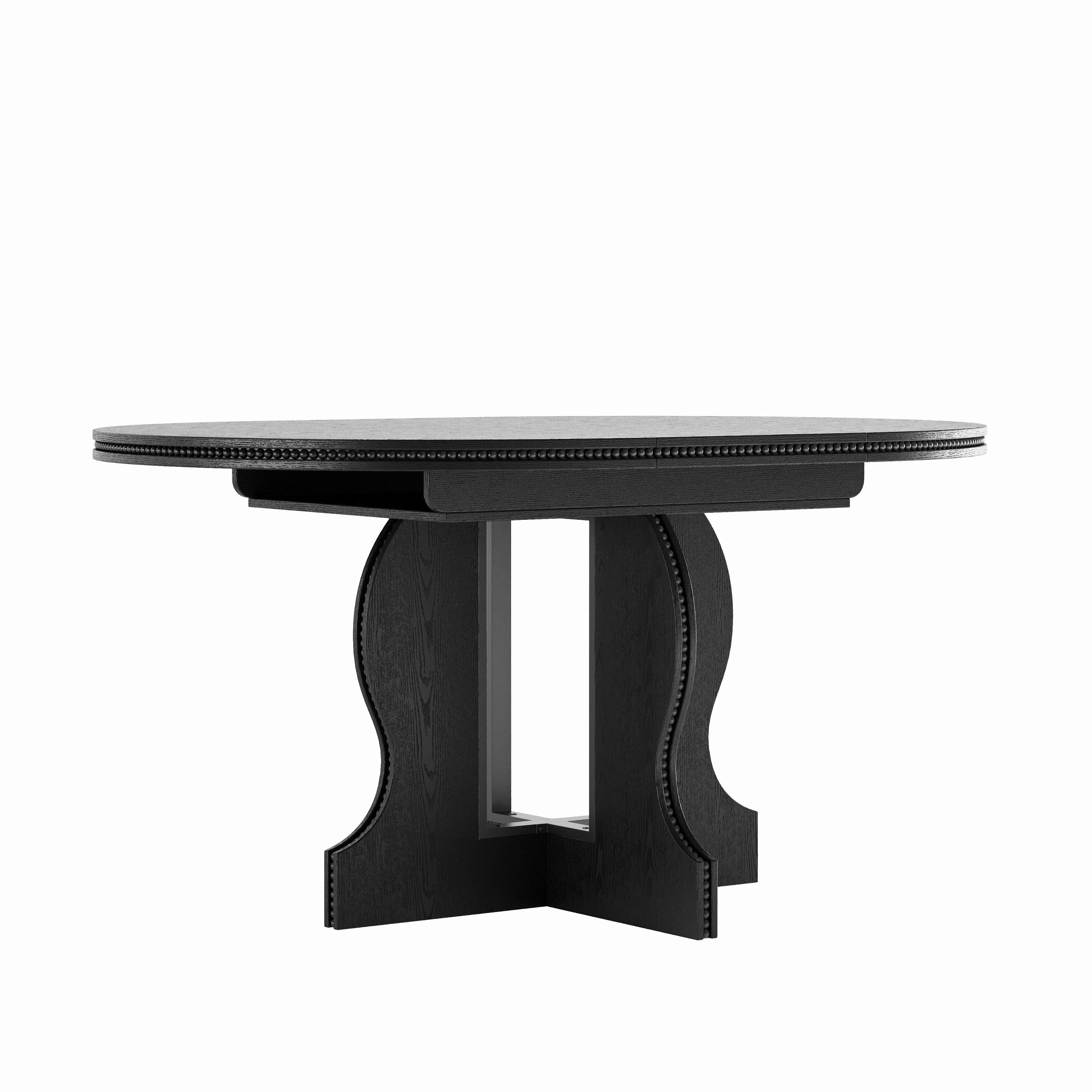 Black round pedestal dining table, three-quarter view on a plain white studio background