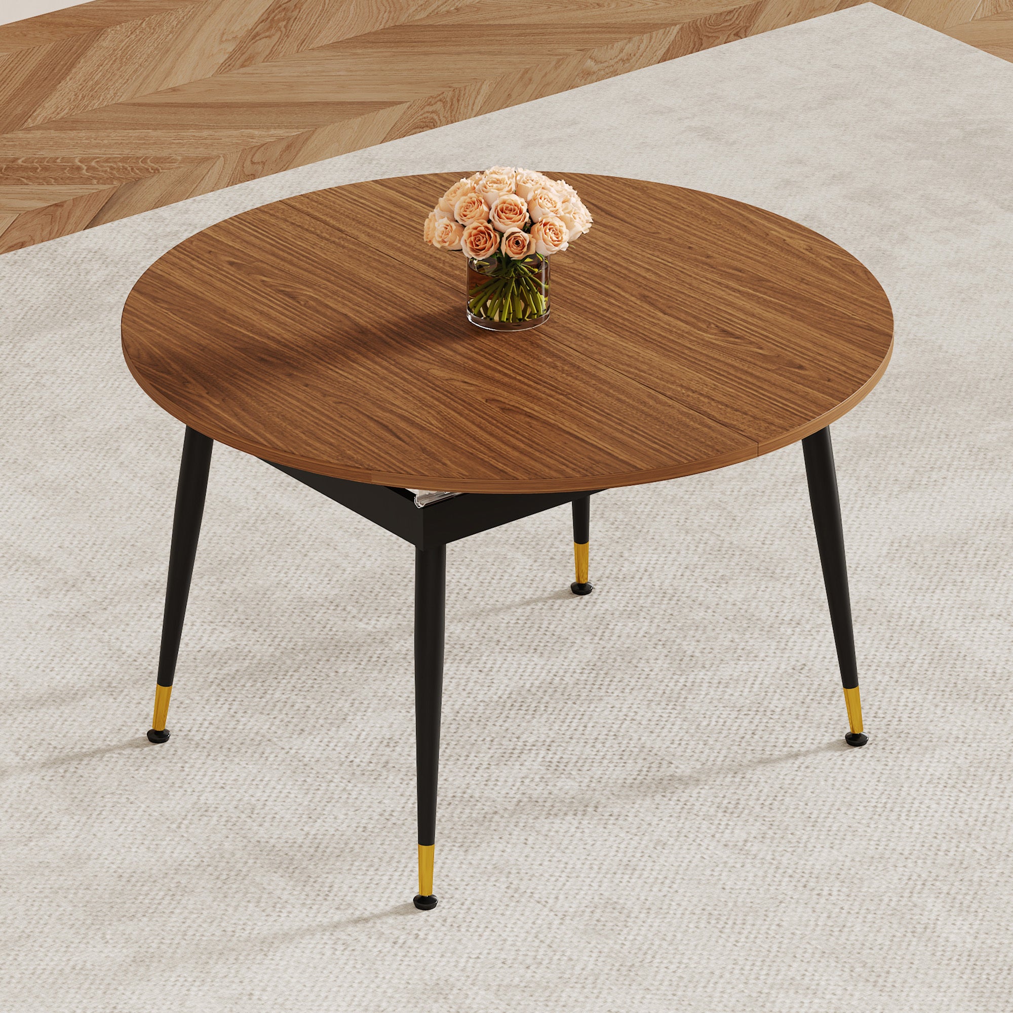 Walnut oval extendable dining table with roses in a styled room with a tall plant