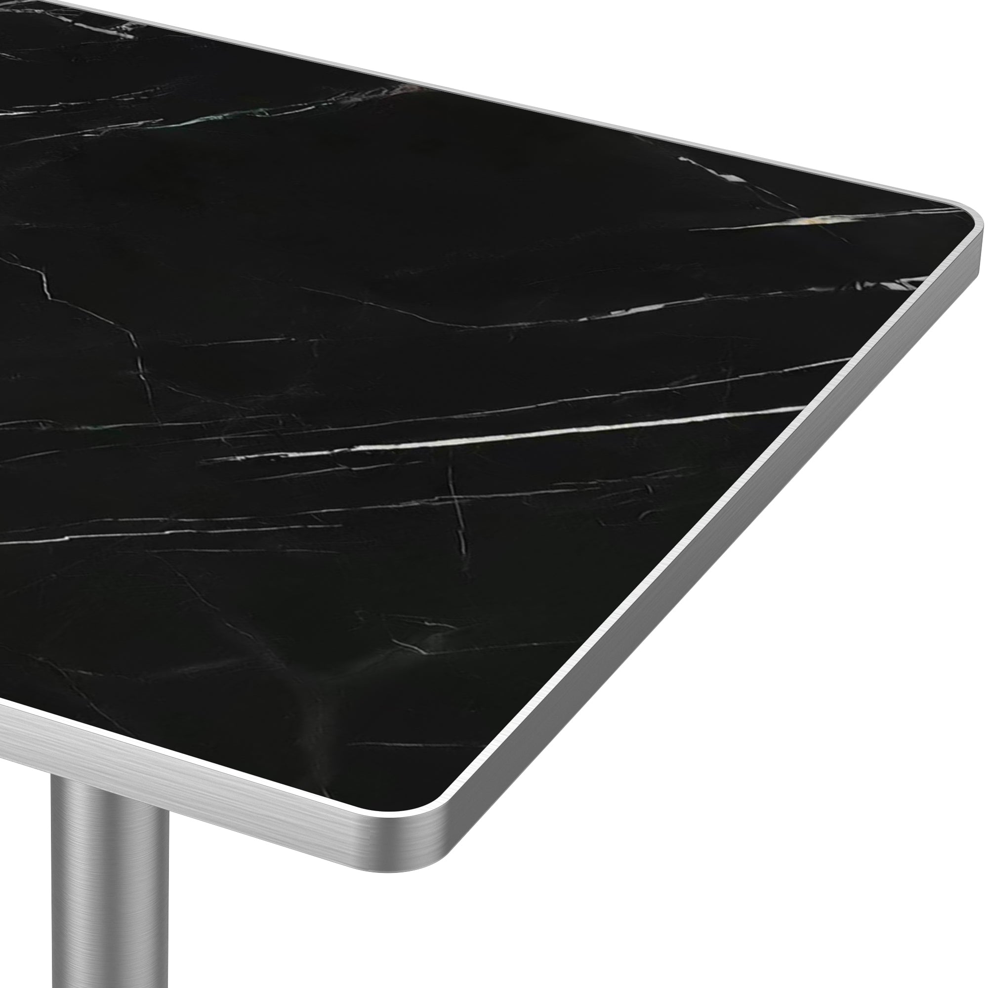 Close-up of black veined sintered stone tabletop corner and brushed silver edge trim