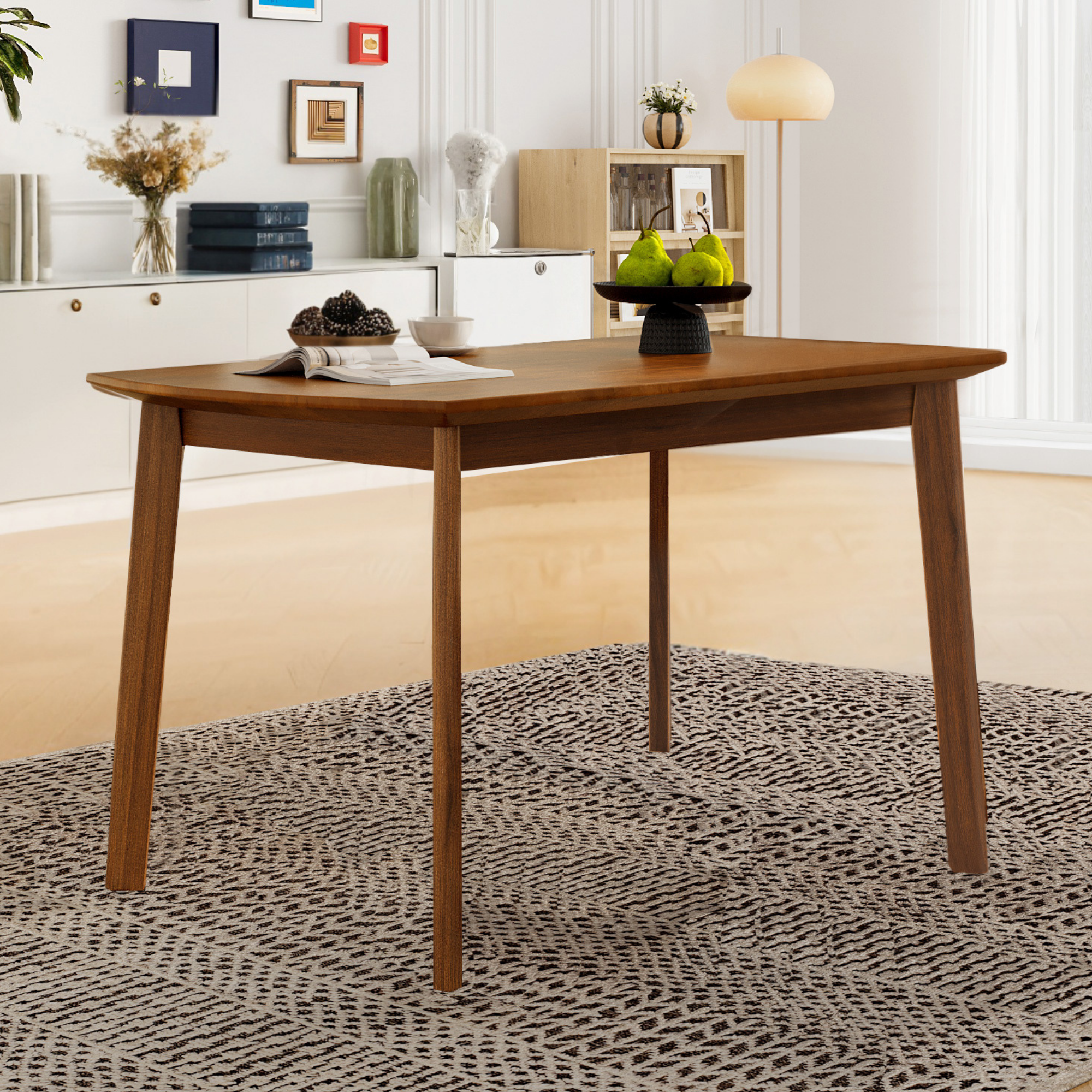 Brown mid-century rectangular dining table with tapered legs styled in a bright room with fruit bowls