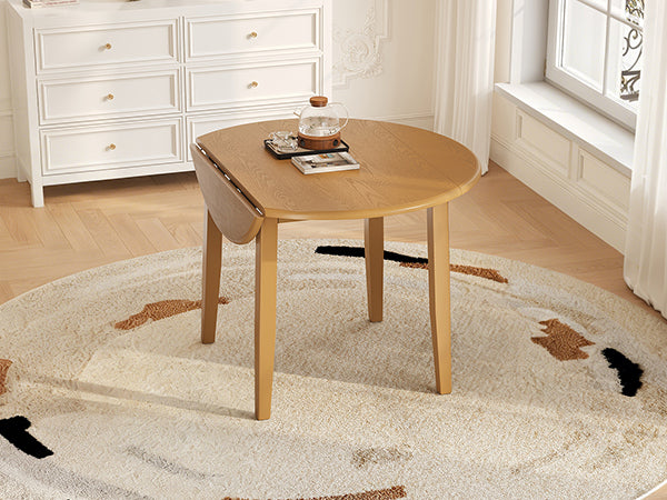 Styled room with the light brown table, one drop leaf folded down by a dresser