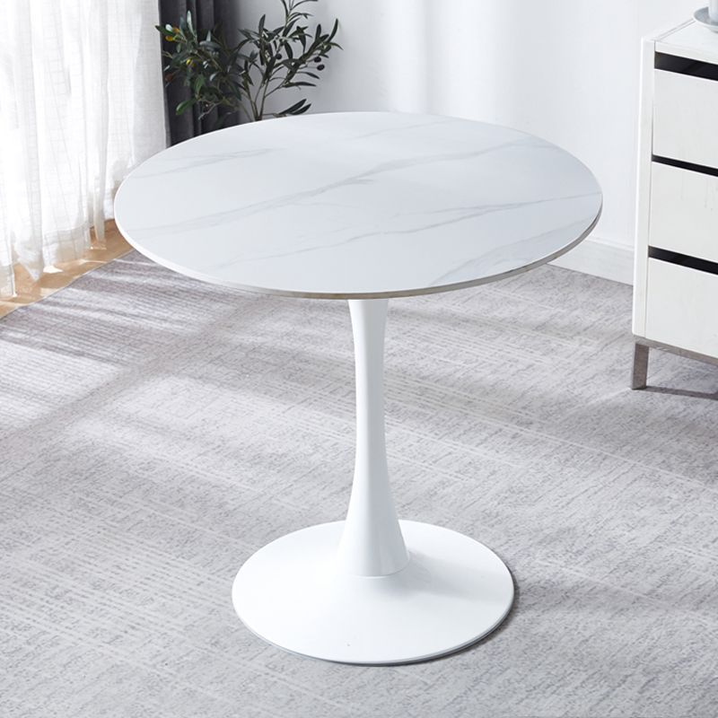 White marble tulip bistro table on a rug in a bright room, three-quarter view