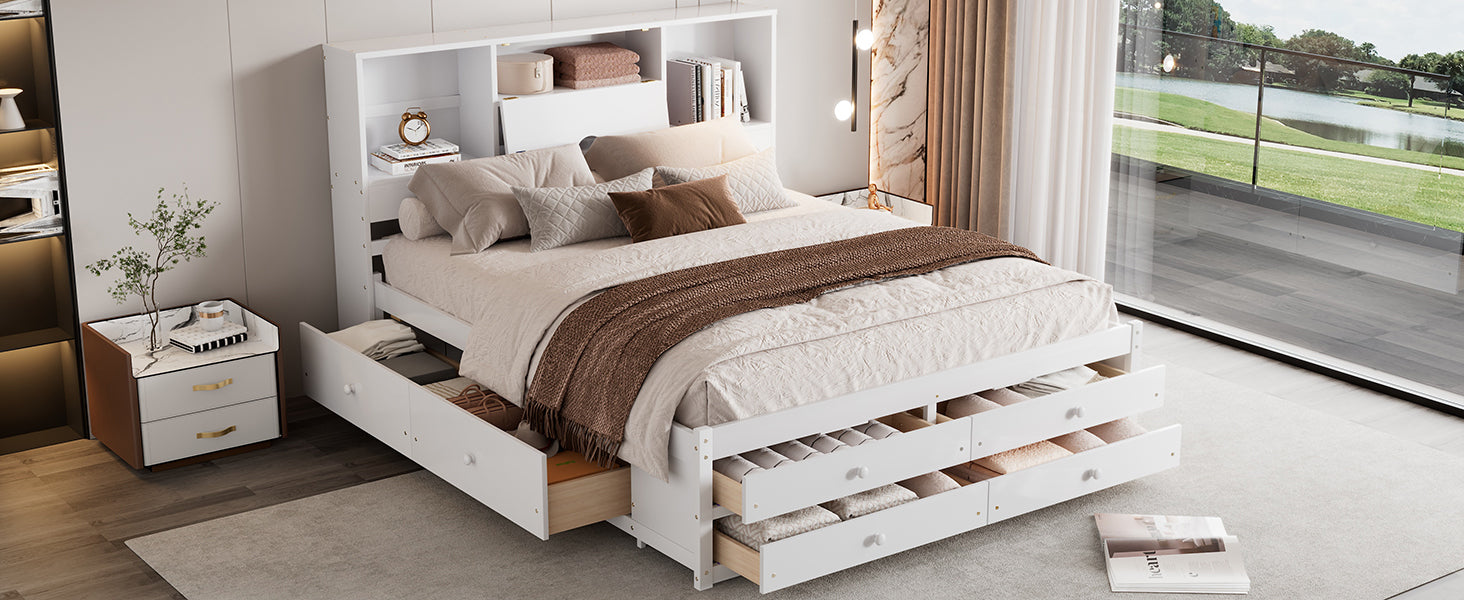 Foot-angle view of the white queen storage bed with all side and footboard drawers pulled out