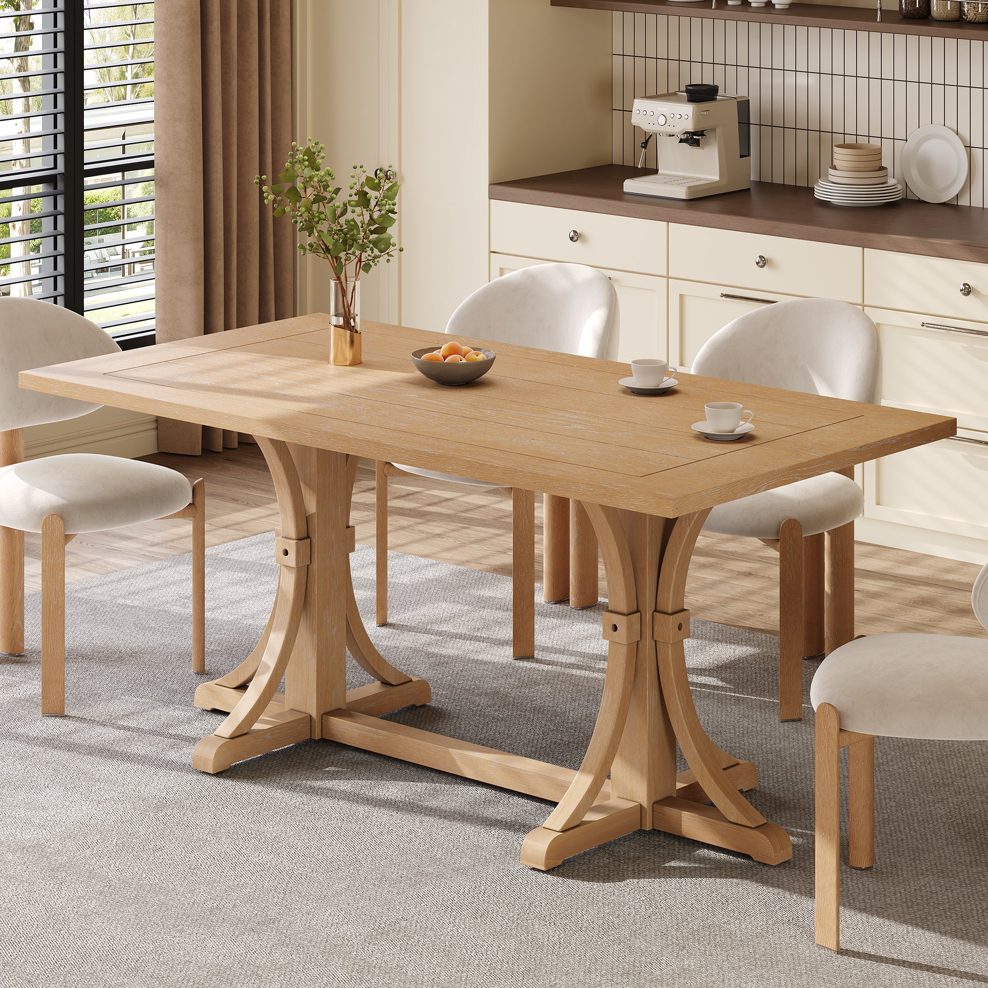 Farmhouse trestle dining table styled in a bright kitchen with cream boucle chairs and coffee setup