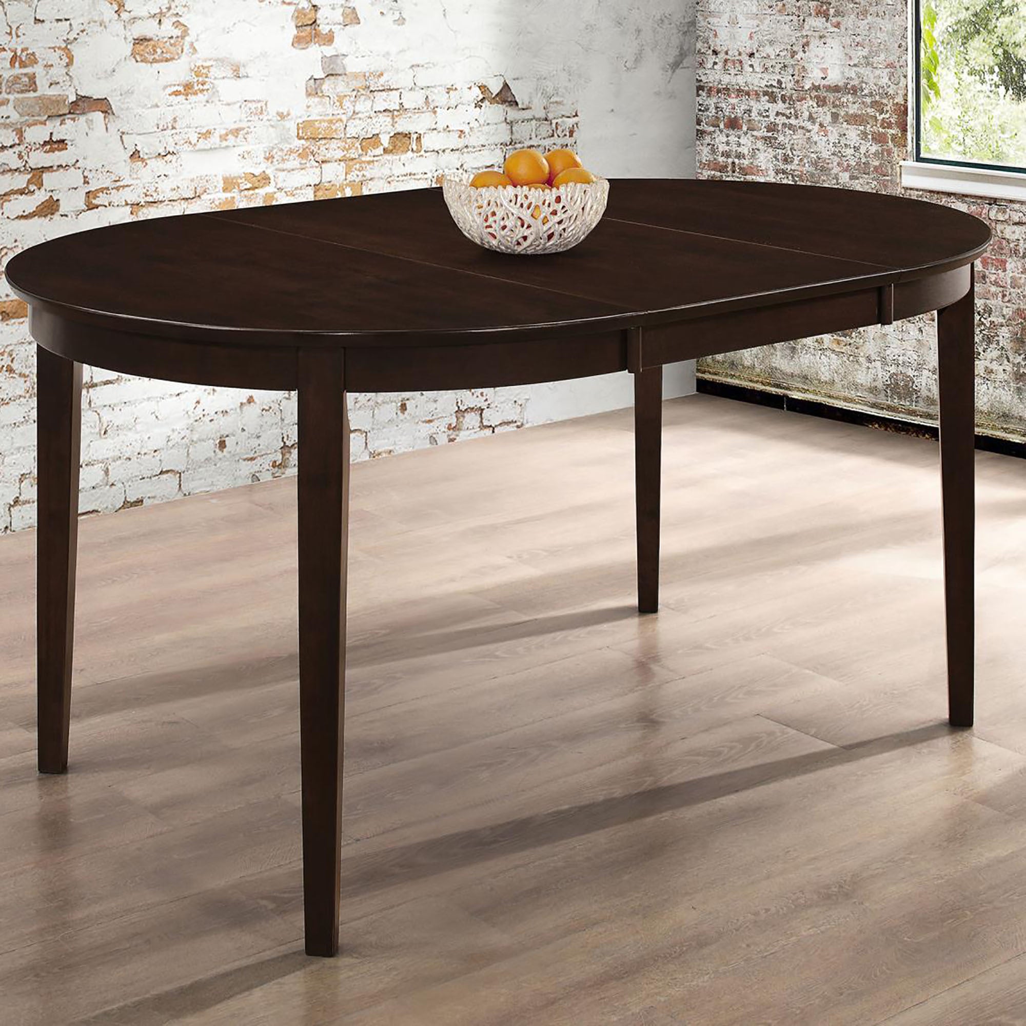 Cappuccino oval extendable dining table with a fruit bowl in a brick-wall room