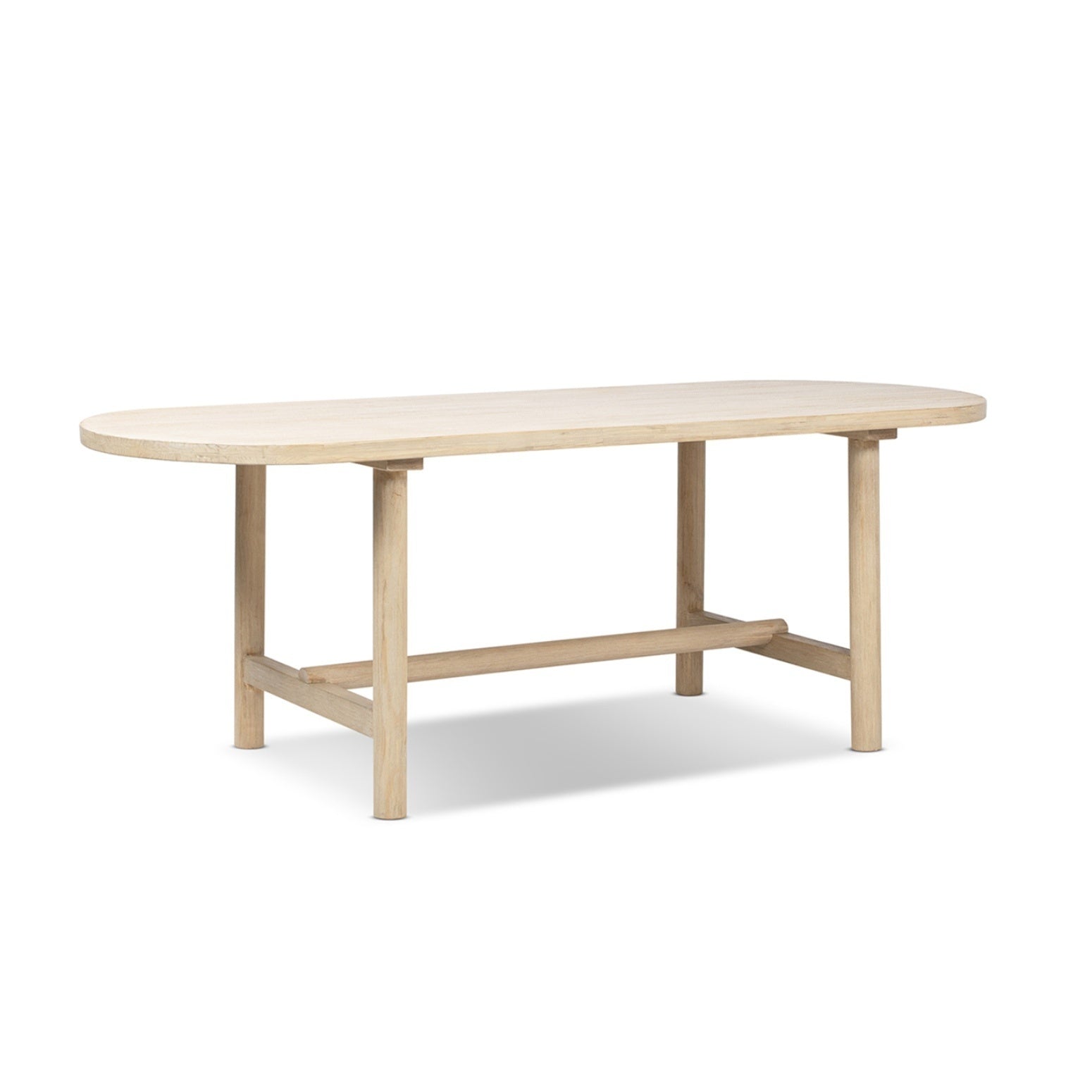 Natural cerused pine oval dining table with trestle base, three-quarter view on white studio background