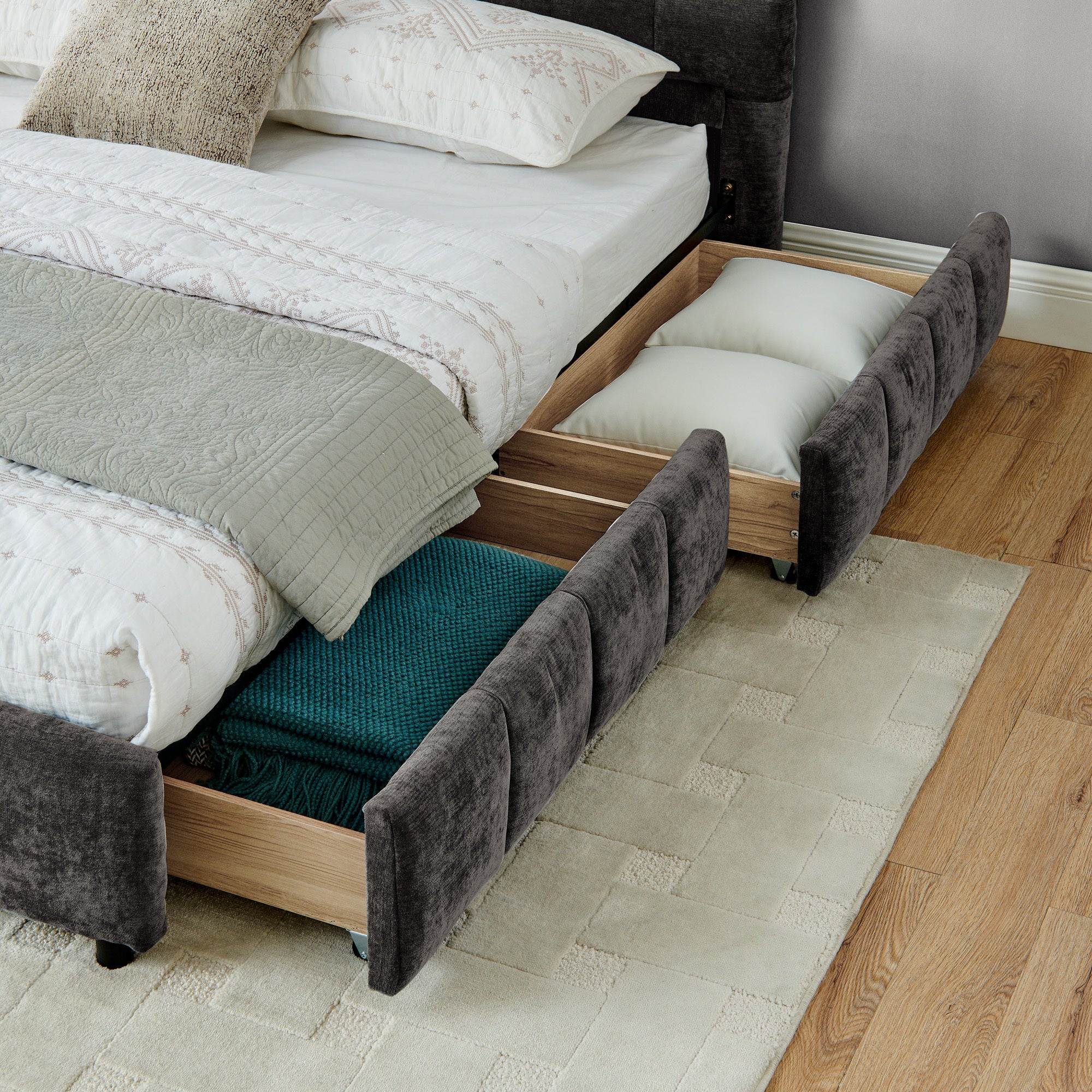 Angled view of dark gray king bed frame with all four drawers open