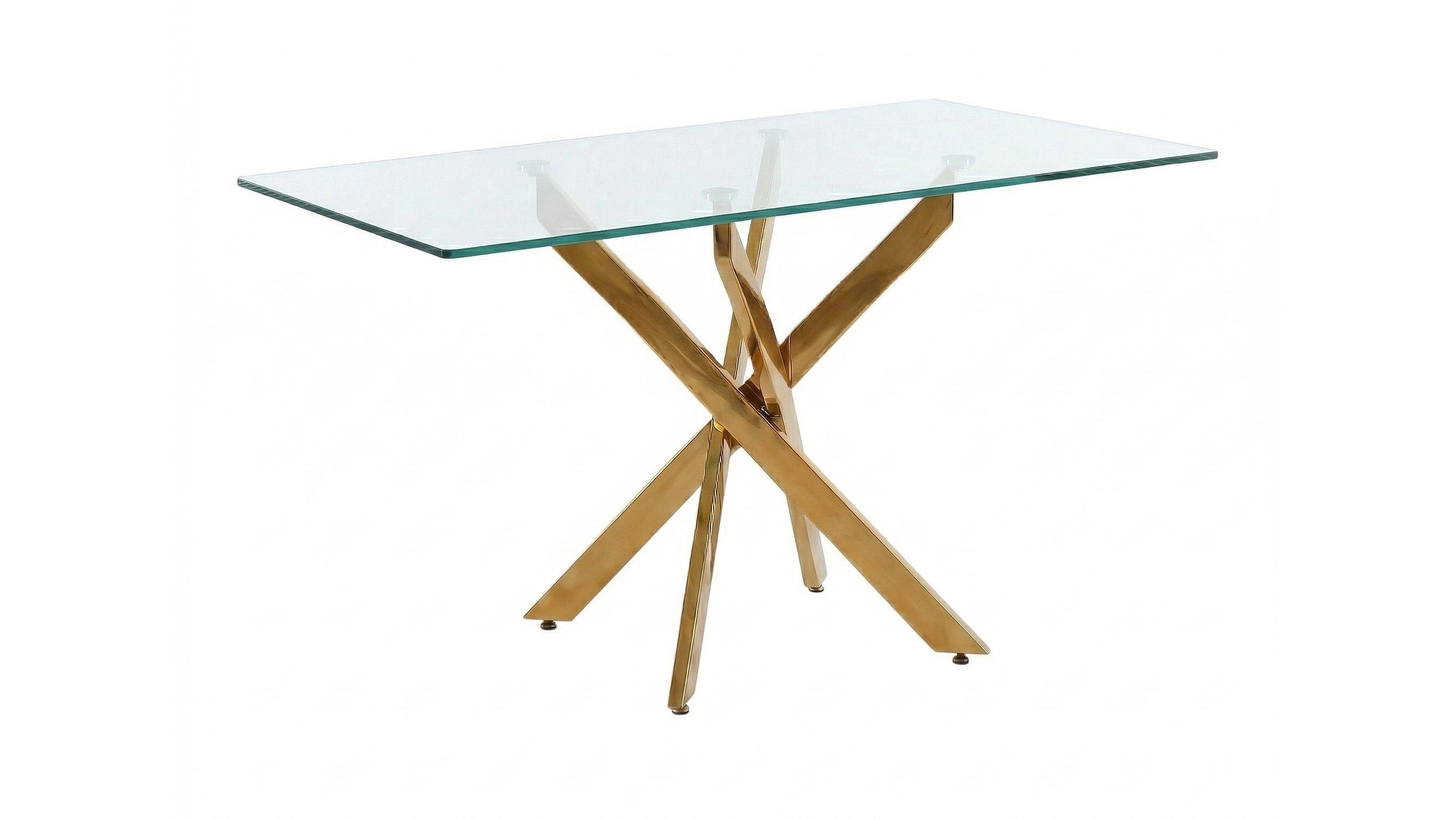Wide side-angled studio view of the glass dining table with gold crisscross legs