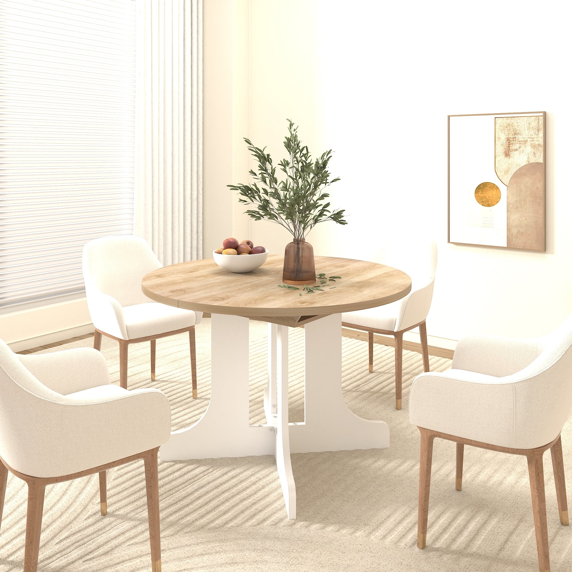 Round oak-top dining table with four cream armchairs below framed abstract art