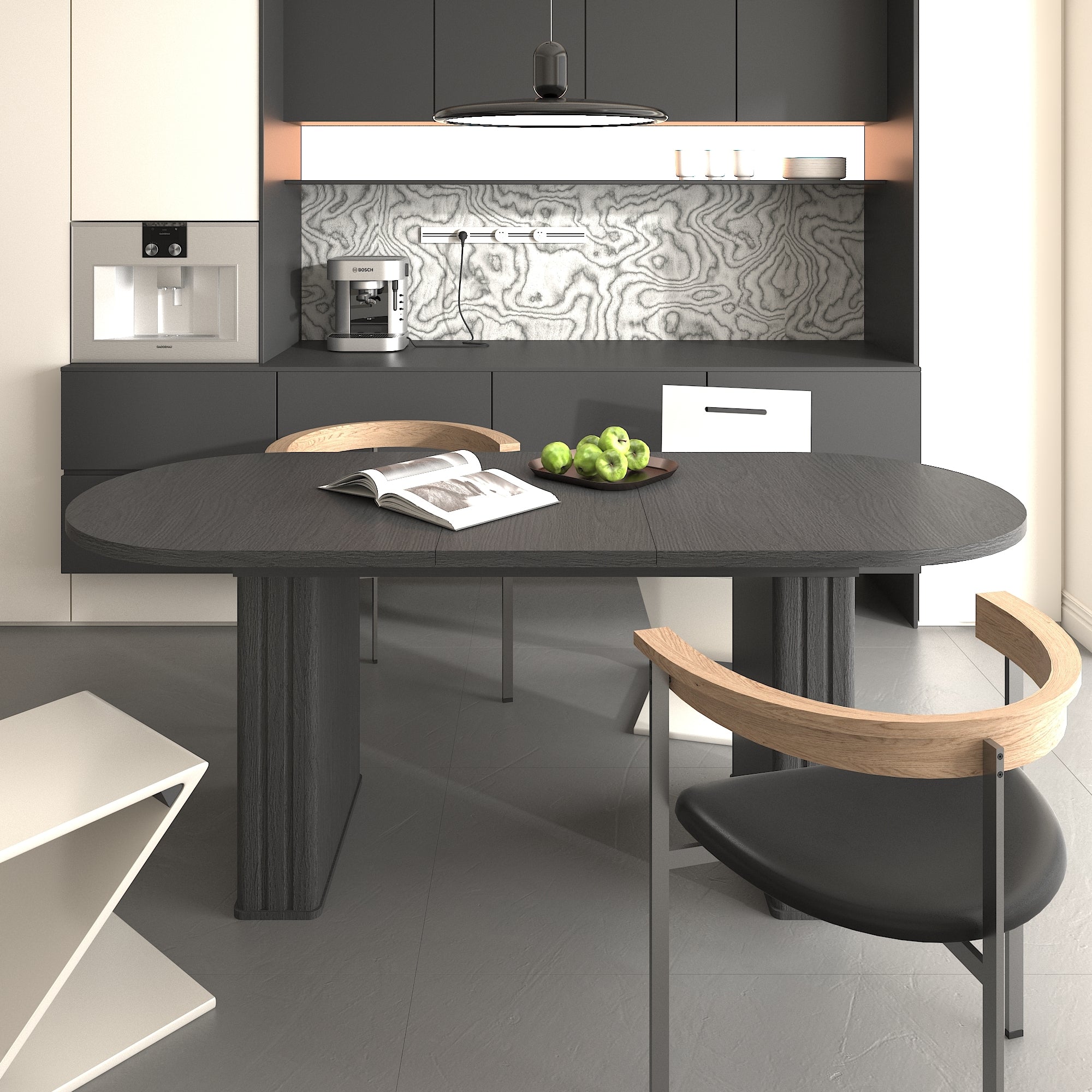Black oval extendable dining table in a modern kitchen, styled with green apples and an open magazine