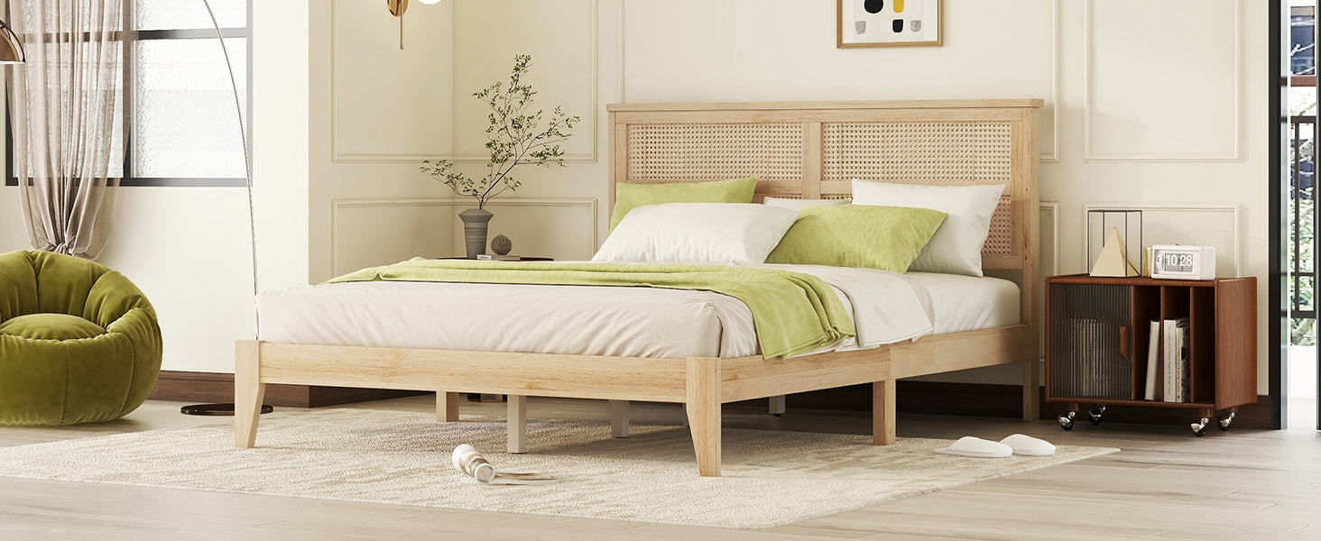 Angled bedroom scene of the rubberwood bed frame with rattan headboard and a green floor cushion
