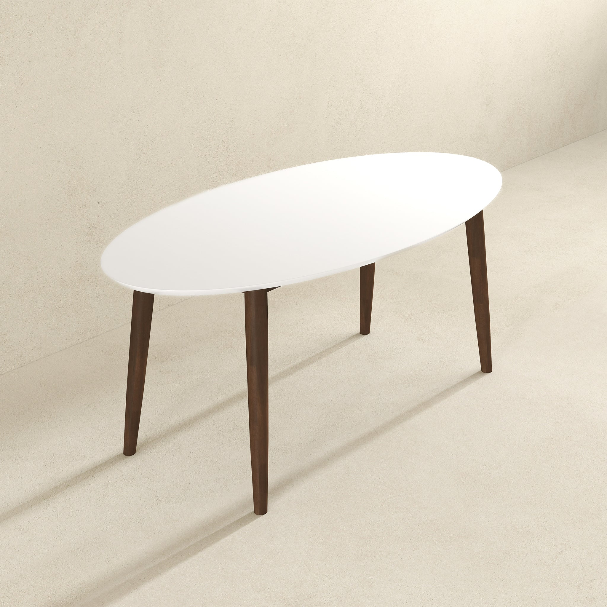 White-top oval dining table with walnut legs, three-quarter view on beige background