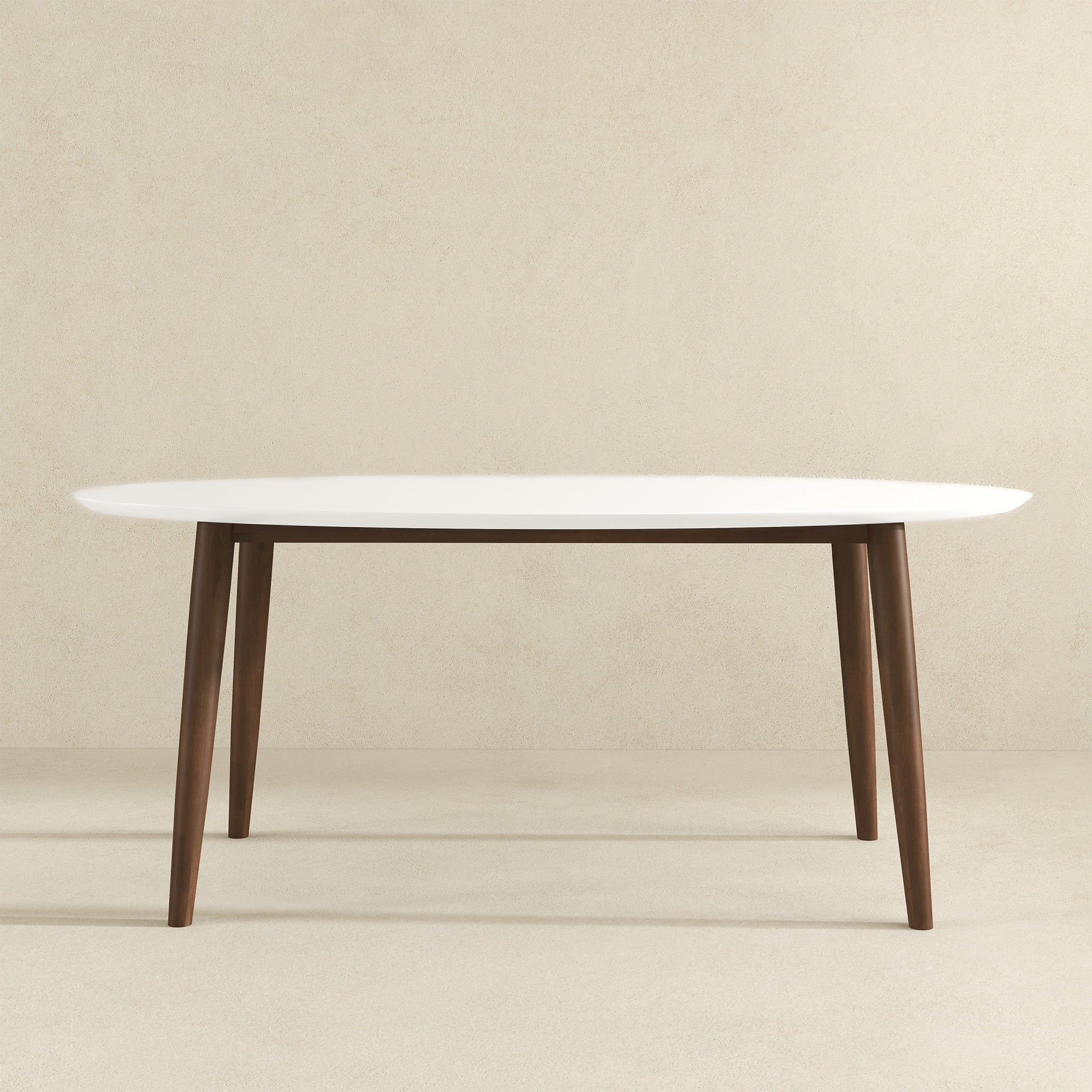 White-top oval dining table, front view on a beige studio background