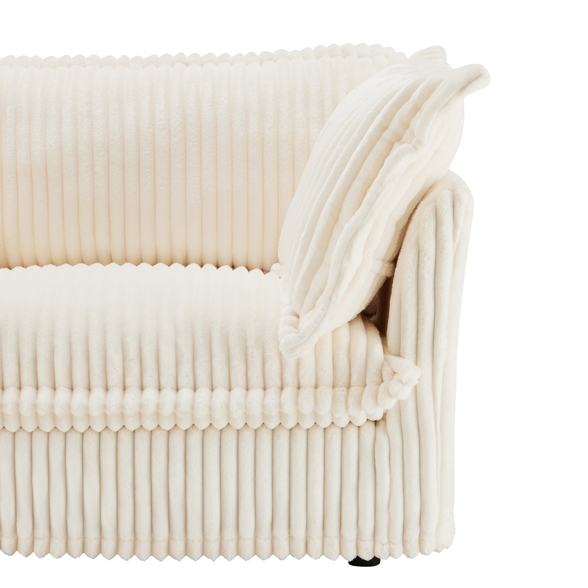 Detail shot of the corner of a cream corduroy couch, showcasing the soft, fluffy texture of the fabric and the high-quality stitching on the removable, washable cover.